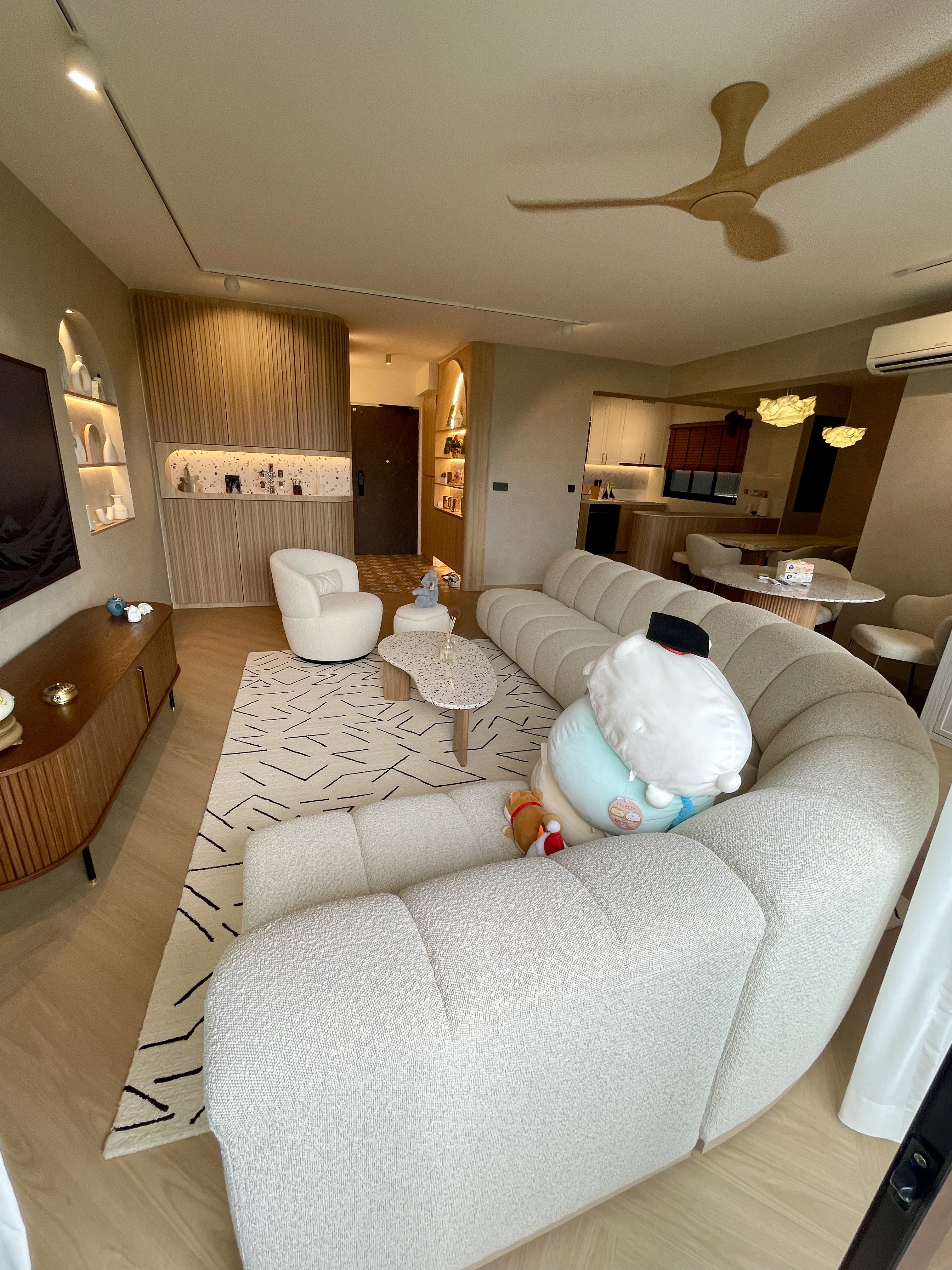 A Self-designed Cosy Abode at Woodleigh Hillside - Modern living room with plush beige sofa, decorative pillows, and plush