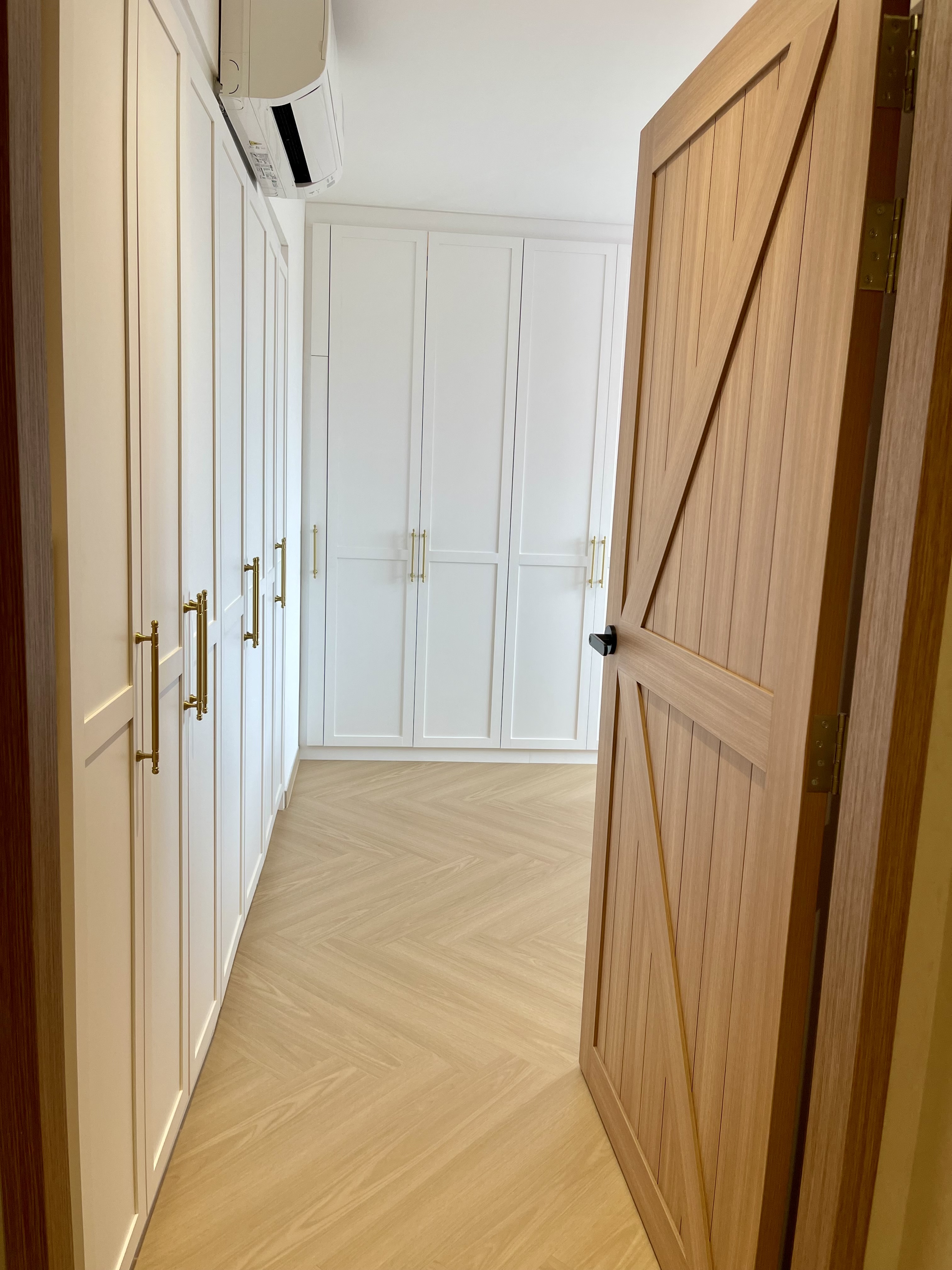 A Self-designed Cosy Abode at Woodleigh Hillside - White cabinetry, wooden doors, herringbone pattern flooring, minimalist