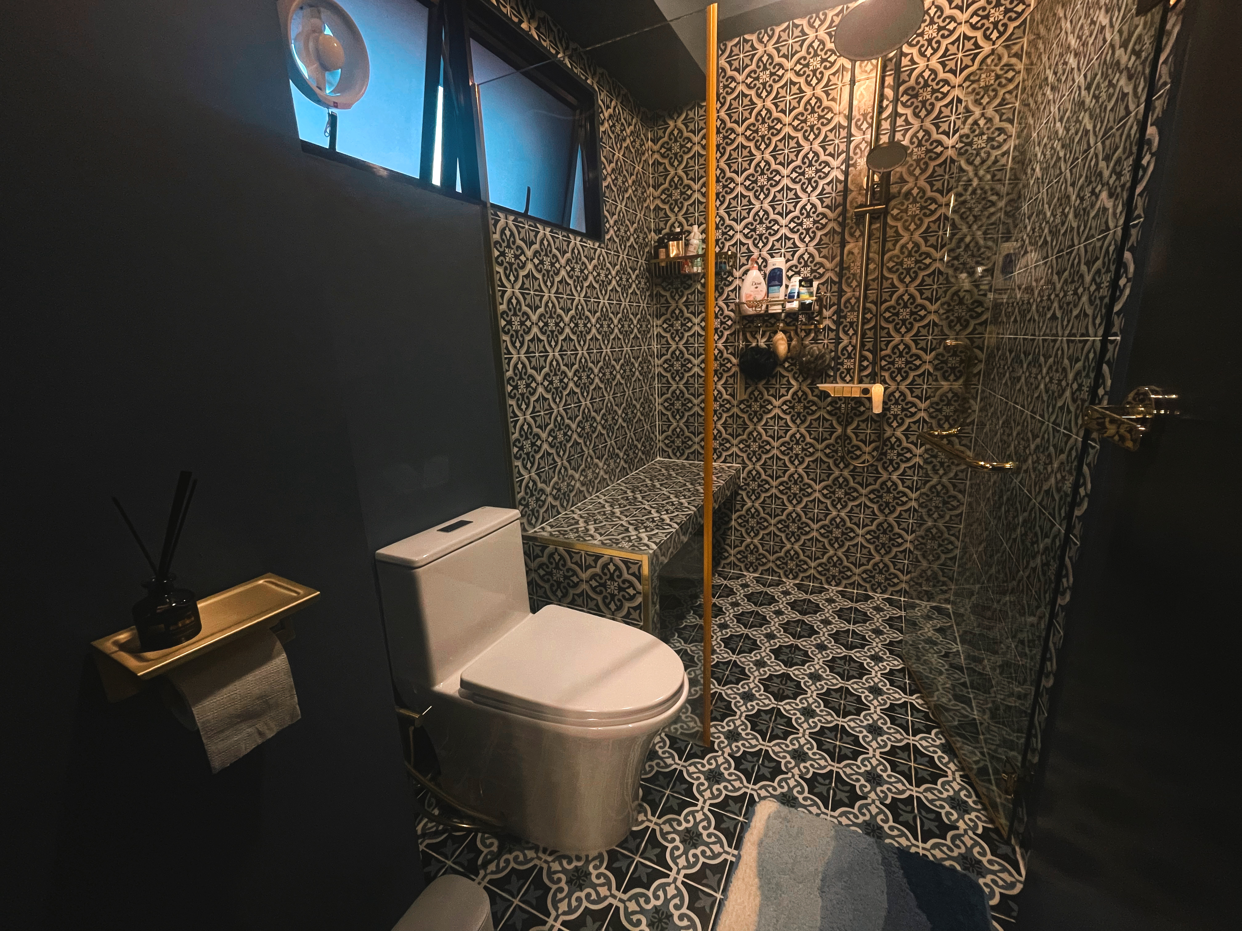 A unique blend of mid-century charm & cottage coziness - Patterned tiles, modern fixtures, dark blue walls, ornate shower