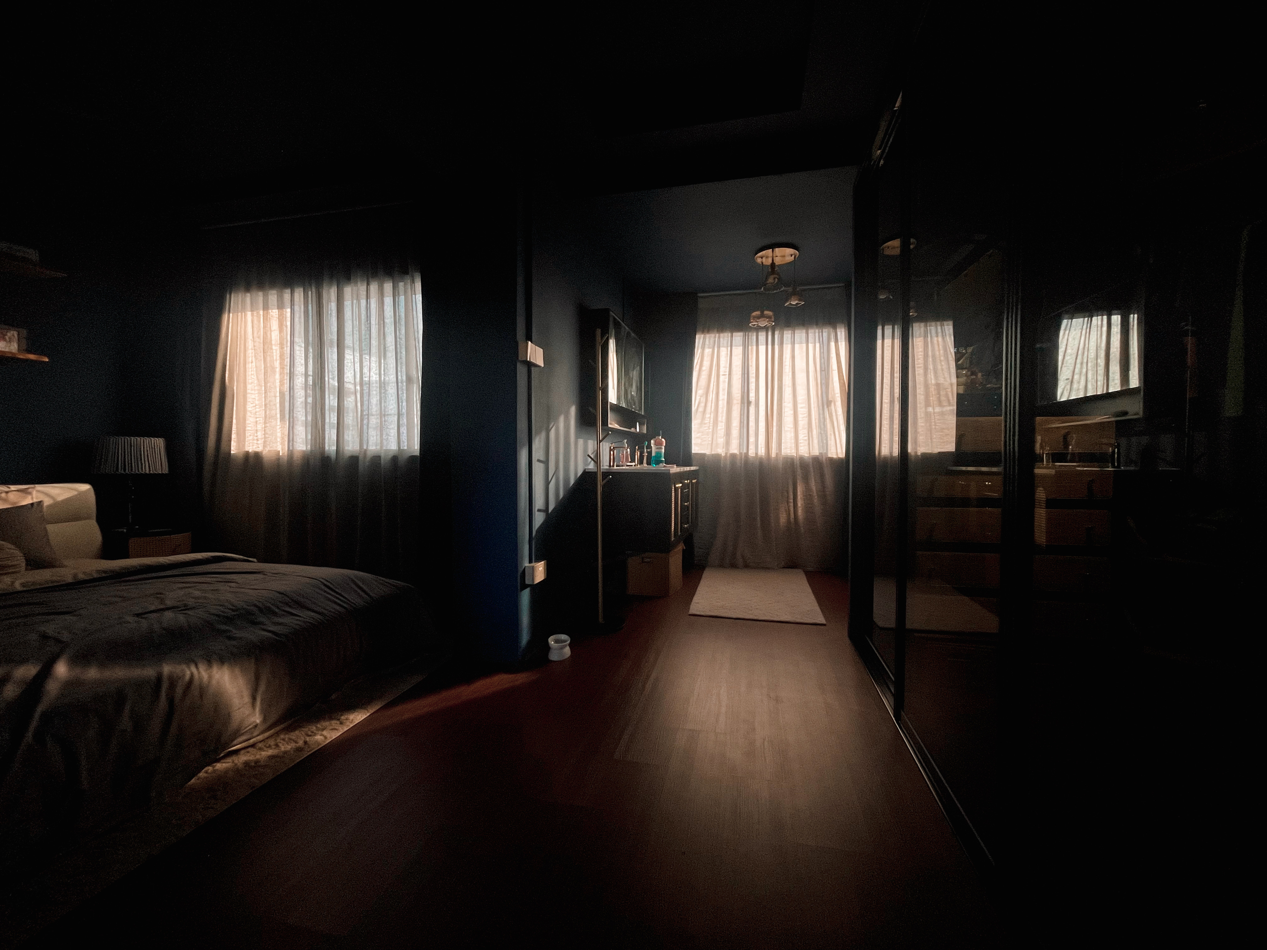 A unique blend of mid-century charm & cottage coziness - dimly lit bedroom, cozy atmosphere, soft lighting, natural light