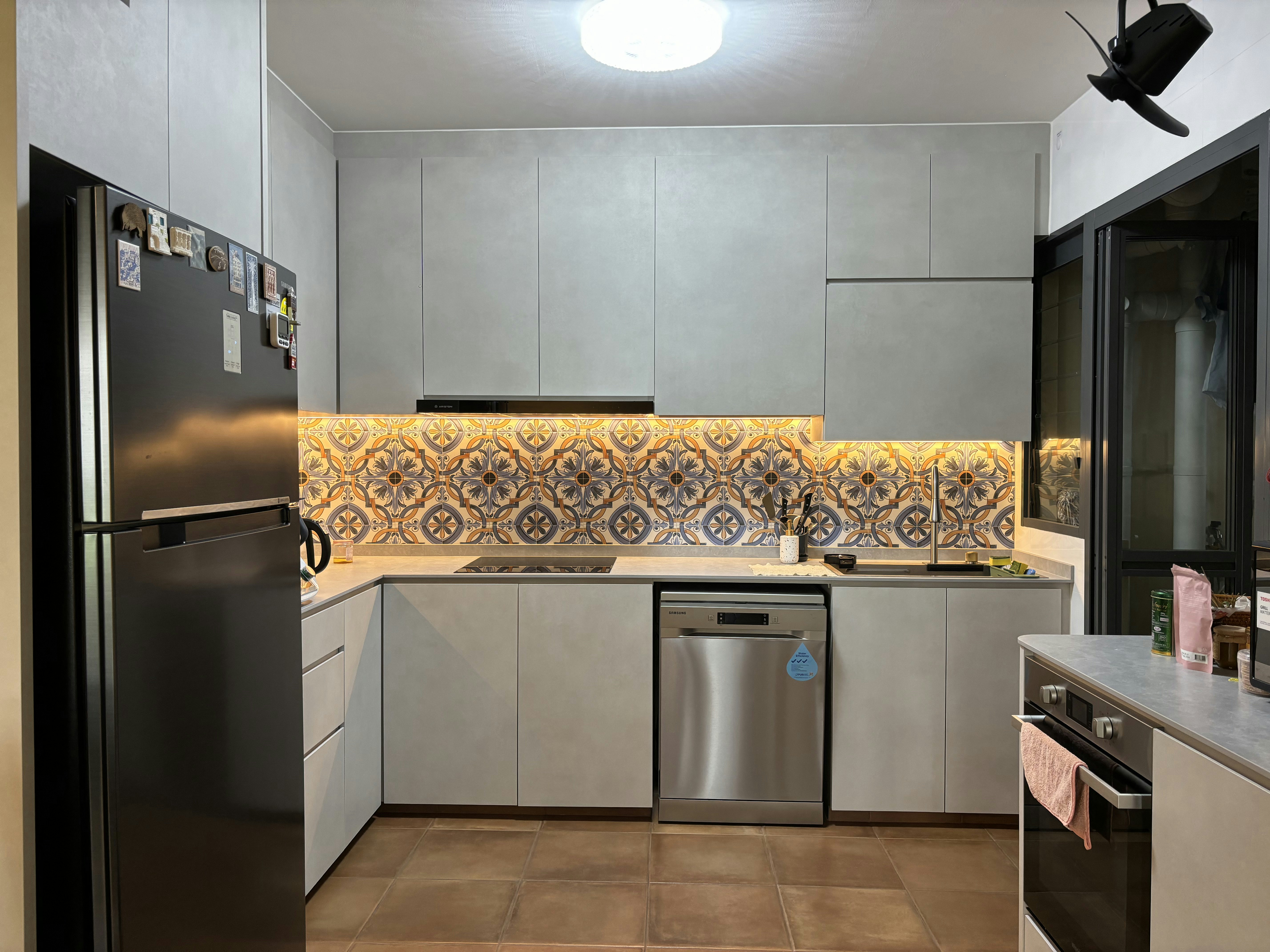 Inside a practical Modern Mediterranean 4RM BTO - Modern kitchen with stainless steel appliances, including a refrigerator