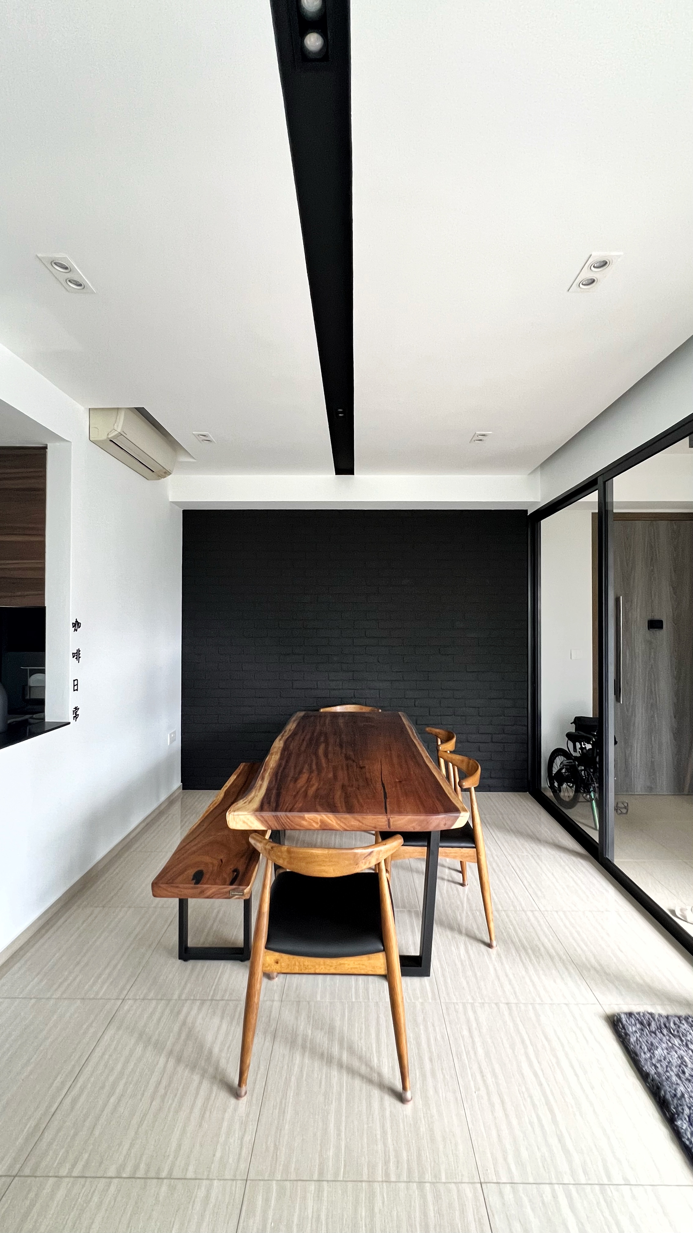 Our little cosmopolitan treehouse! - Modern minimalist dining room, sleek wooden table, black brick accent wall, contemporary