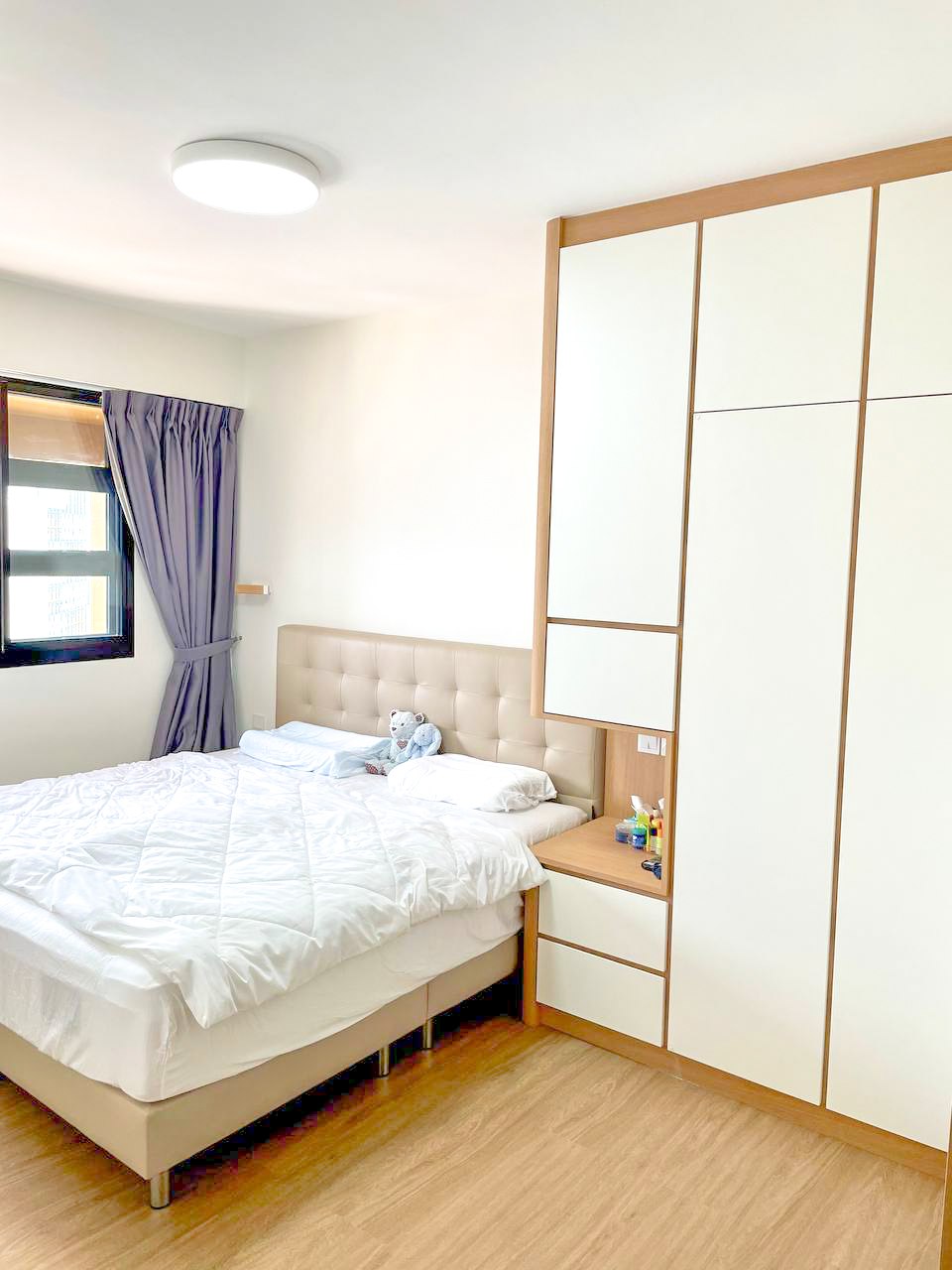 A Japandi Home with a Blue Heart under $30k - Modern bedroom with minimalist design, large bed with white comforter, plush