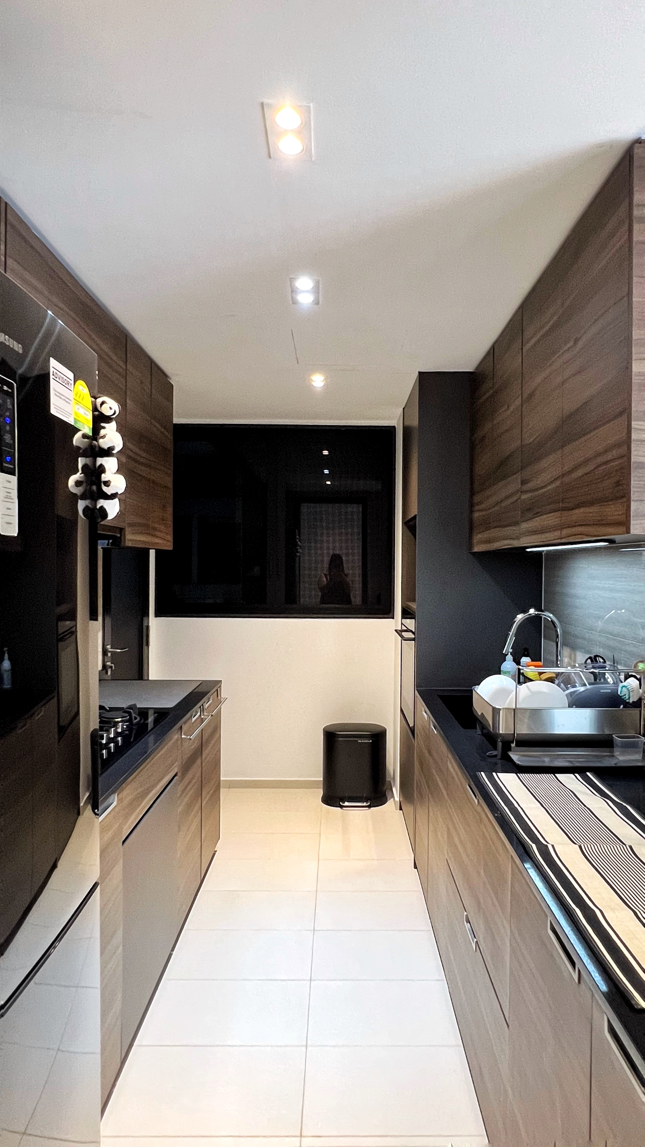 Our little cosmopolitan treehouse! - Modern kitchen with sleek design, dark wood cabinets, stainless steel appliances, black