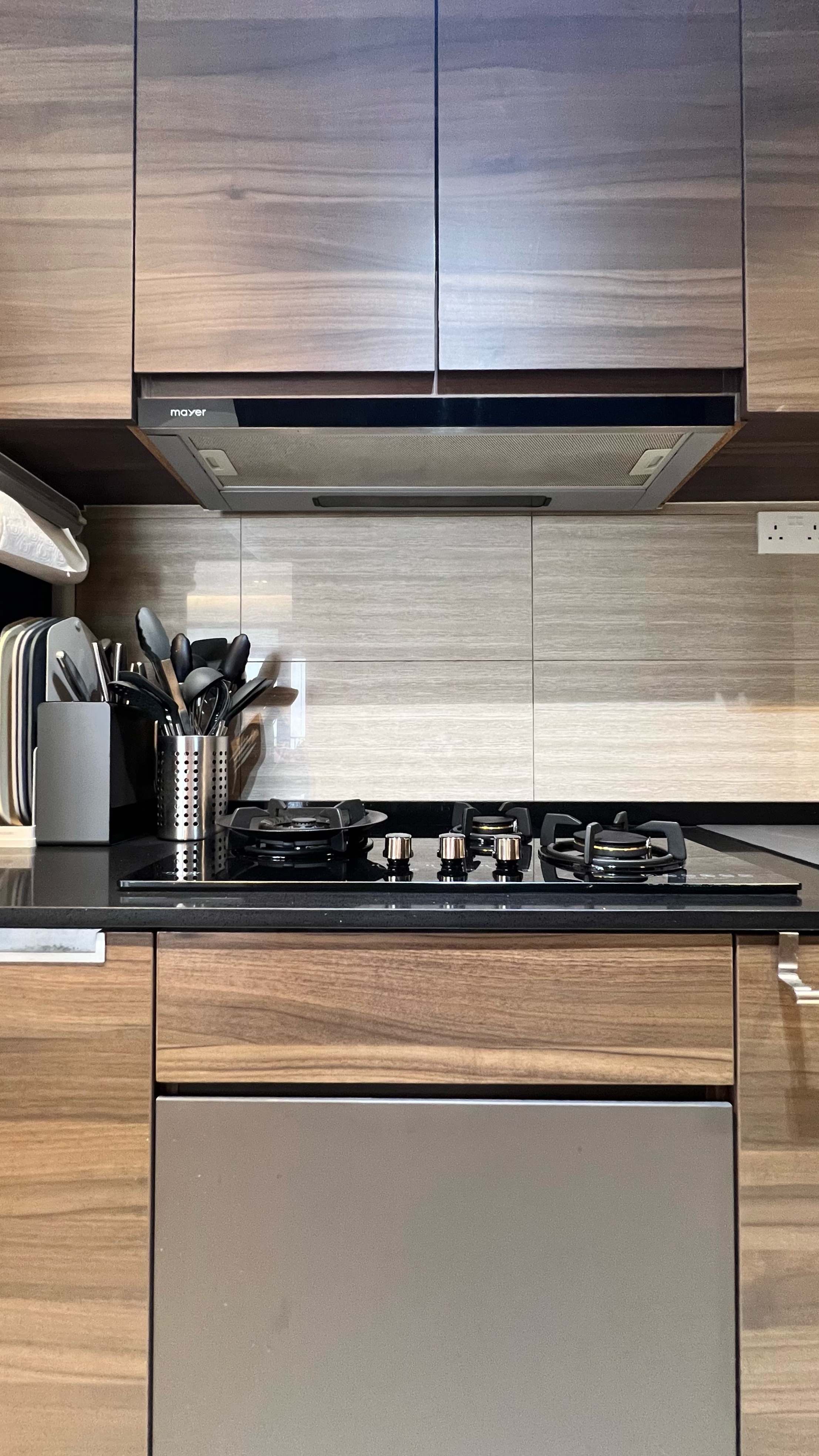 Our little cosmopolitan treehouse! - Wooden kitchen cabinets, black granite countertop, stainless steel range hood, modern