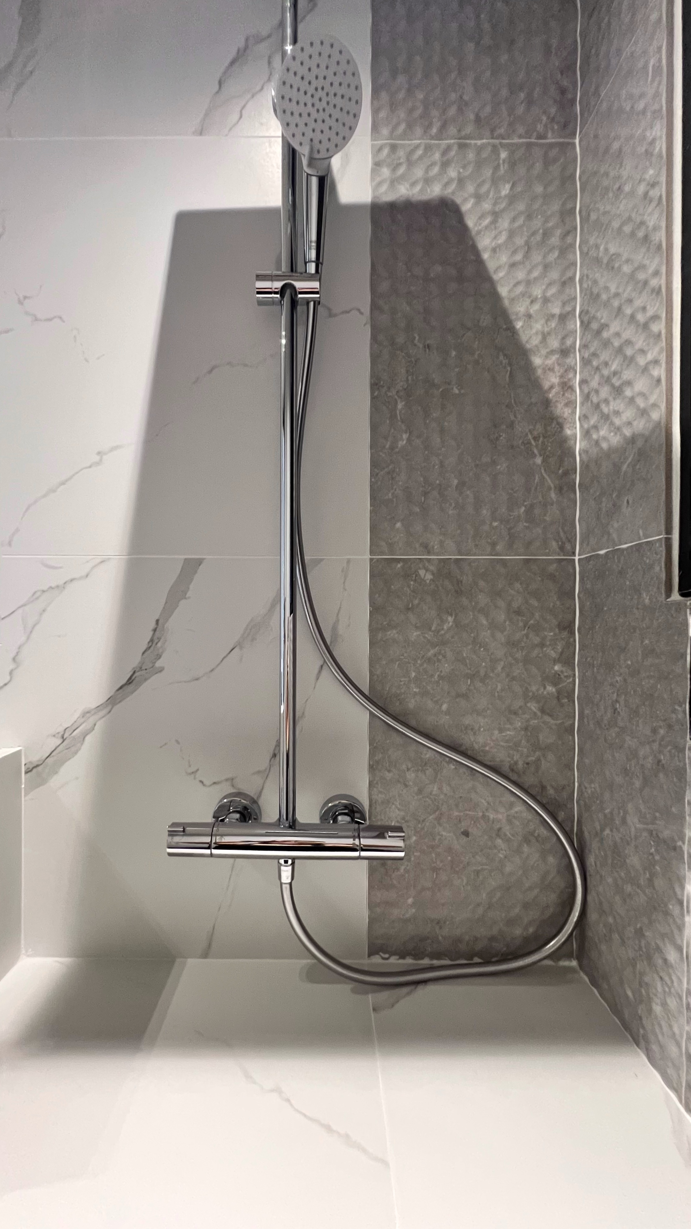 Our little cosmopolitan treehouse! - Modern bathroom, sleek shower, chrome fixtures, dual showerhead, textured tiles, elegant