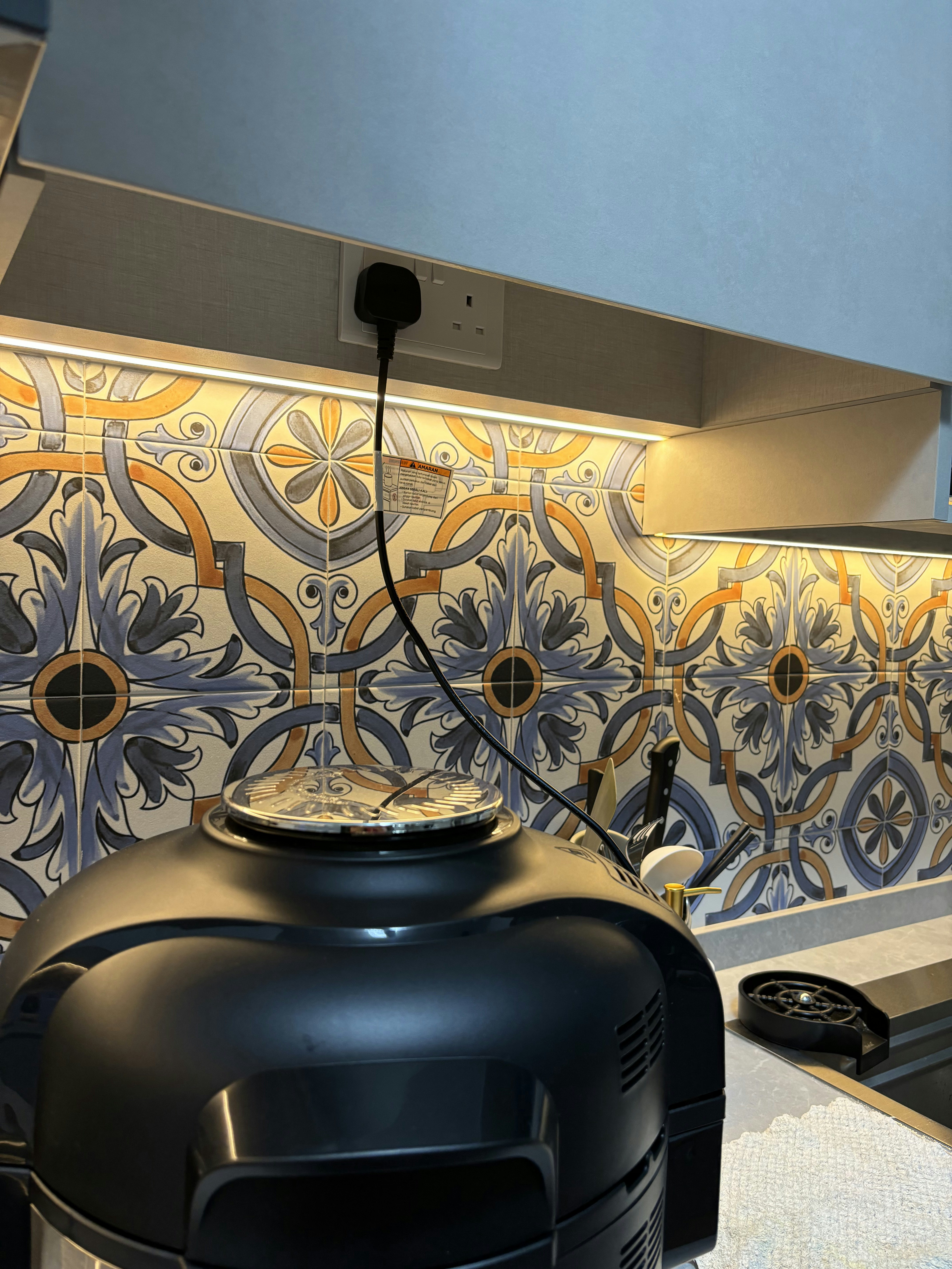 Inside a practical Modern Mediterranean 4RM BTO - Decorative tiles with intricate patterns, kitchen appliances, black