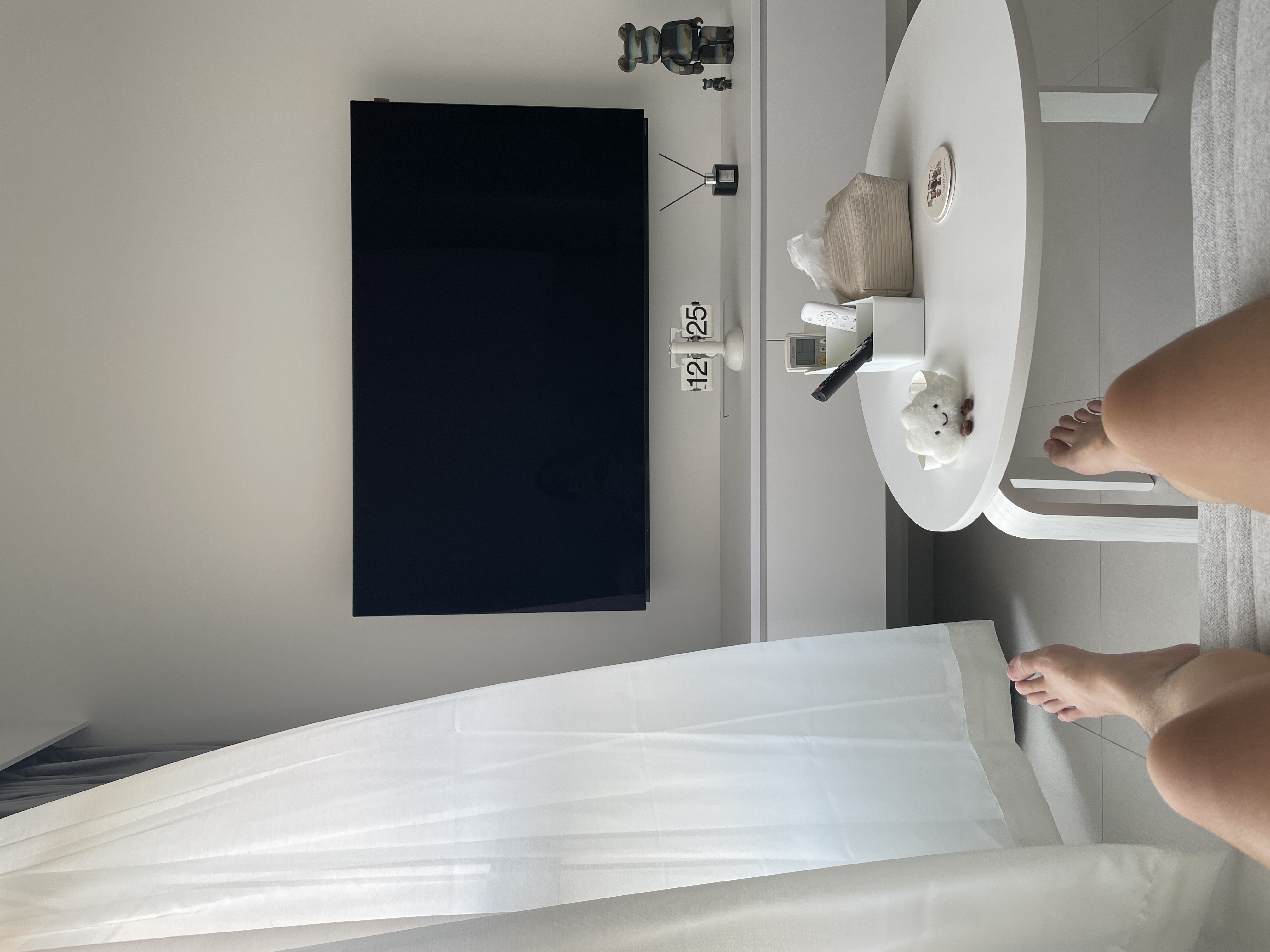 A Peek Inside Our Minimalist Sanctuary  - Modern minimalist living room, sleek black TV, white circular table, white