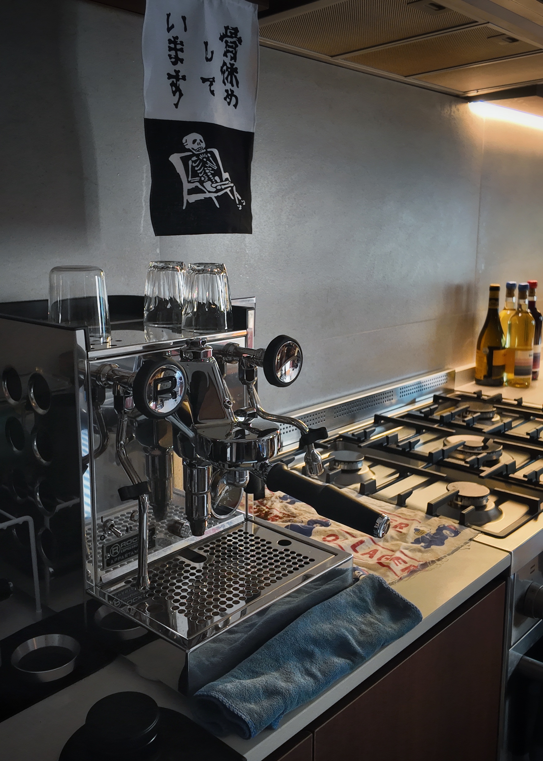 A moody vintage walk-up apartment in Lavender - stainless steel espresso machine, modern kitchen, coffee preparation