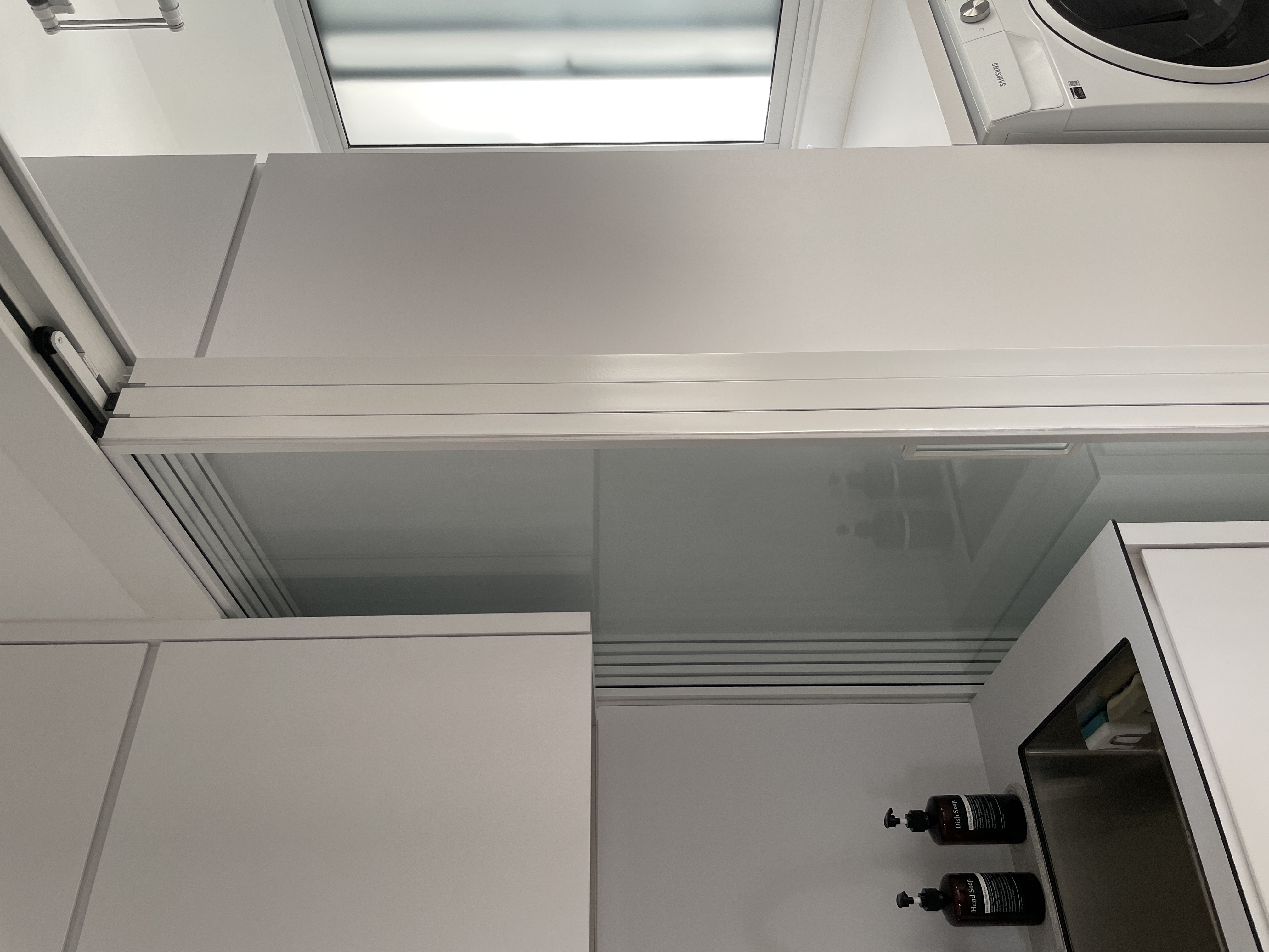 A Peek Inside Our Minimalist Sanctuary  - White kitchen cabinets, modern appliances, glass door refrigerator, stainless steel