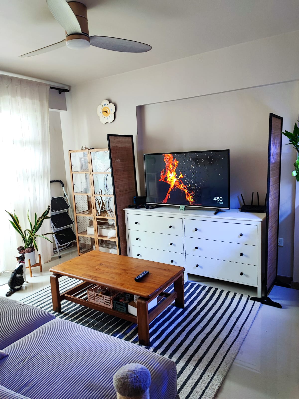 Welcome to our 15K modest & minimal home with 2 cats - Living room, modern decor, cozy atmosphere, TV on, fireplace effect