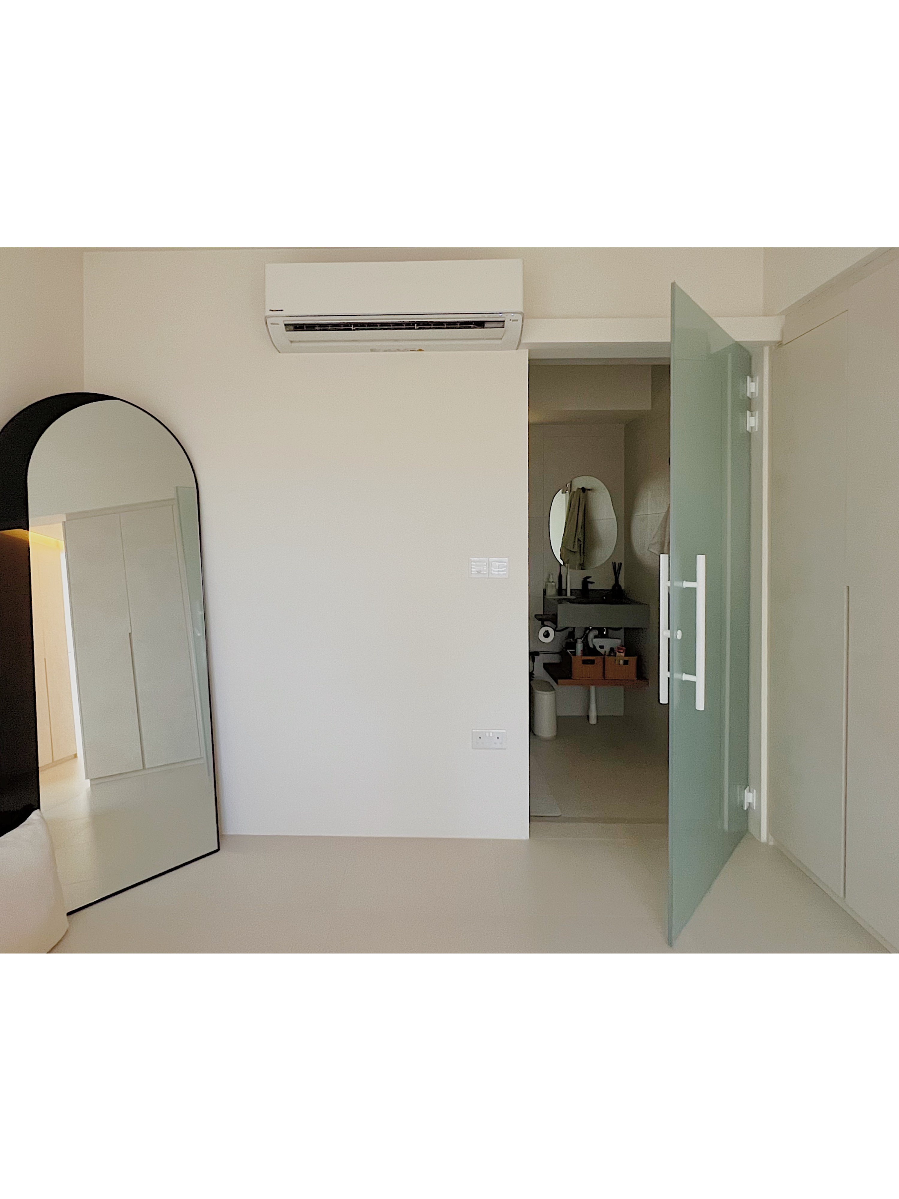 Neutral Palette Japandi Haven in Tampines  - Minimalist room with white walls, modern mirror, arched doorway, open door, air