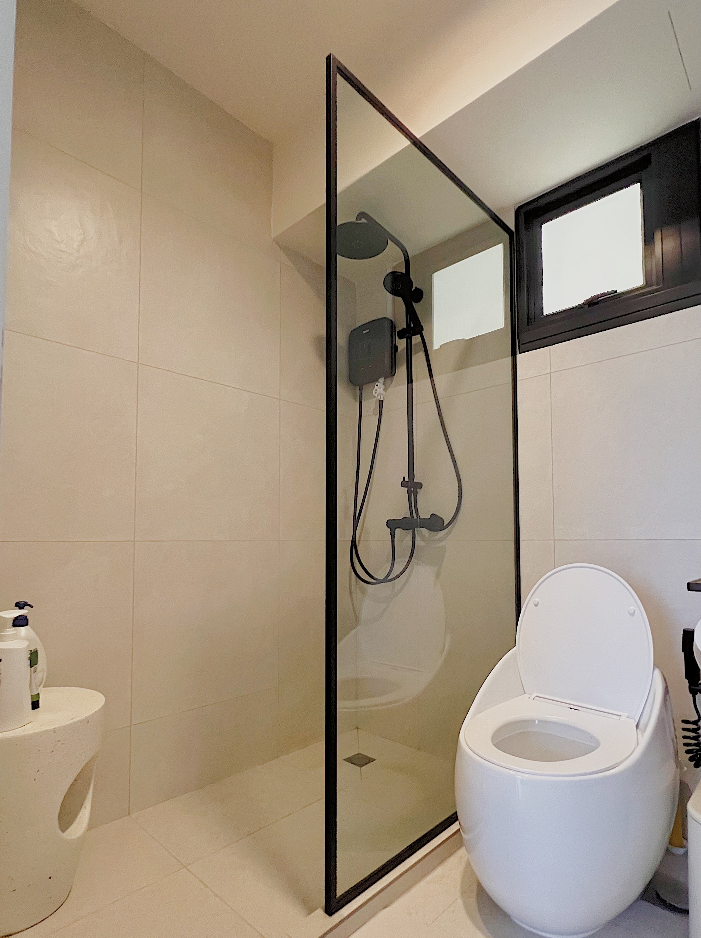 Neutral Palette Japandi Haven in Tampines  - Glass-enclosed shower with modern fixtures, sleek black frame, minimalist