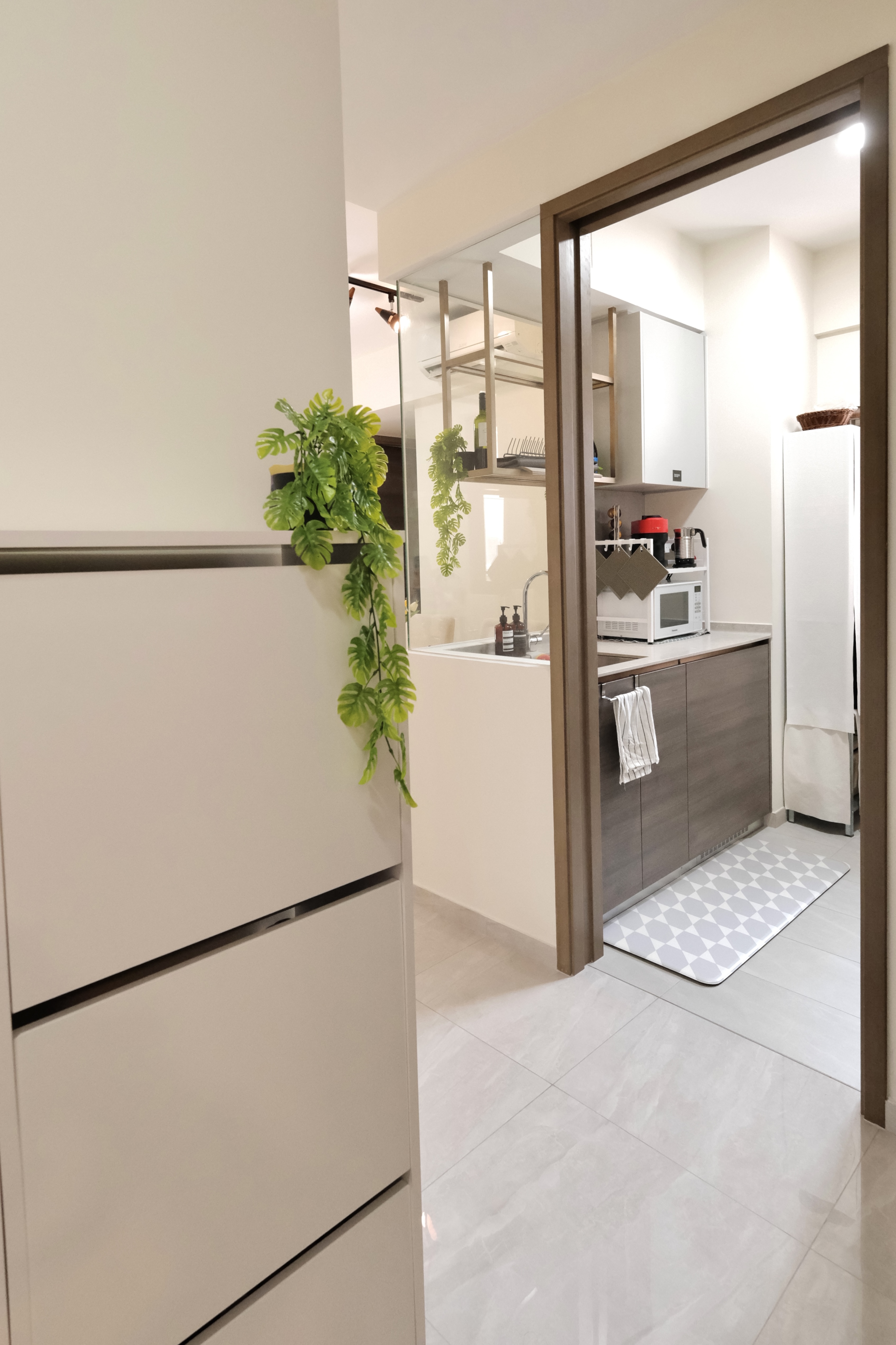 Minimalist Cozy Living in the North-East - Modern kitchen with sleek design, minimalist decor, white cabinets and