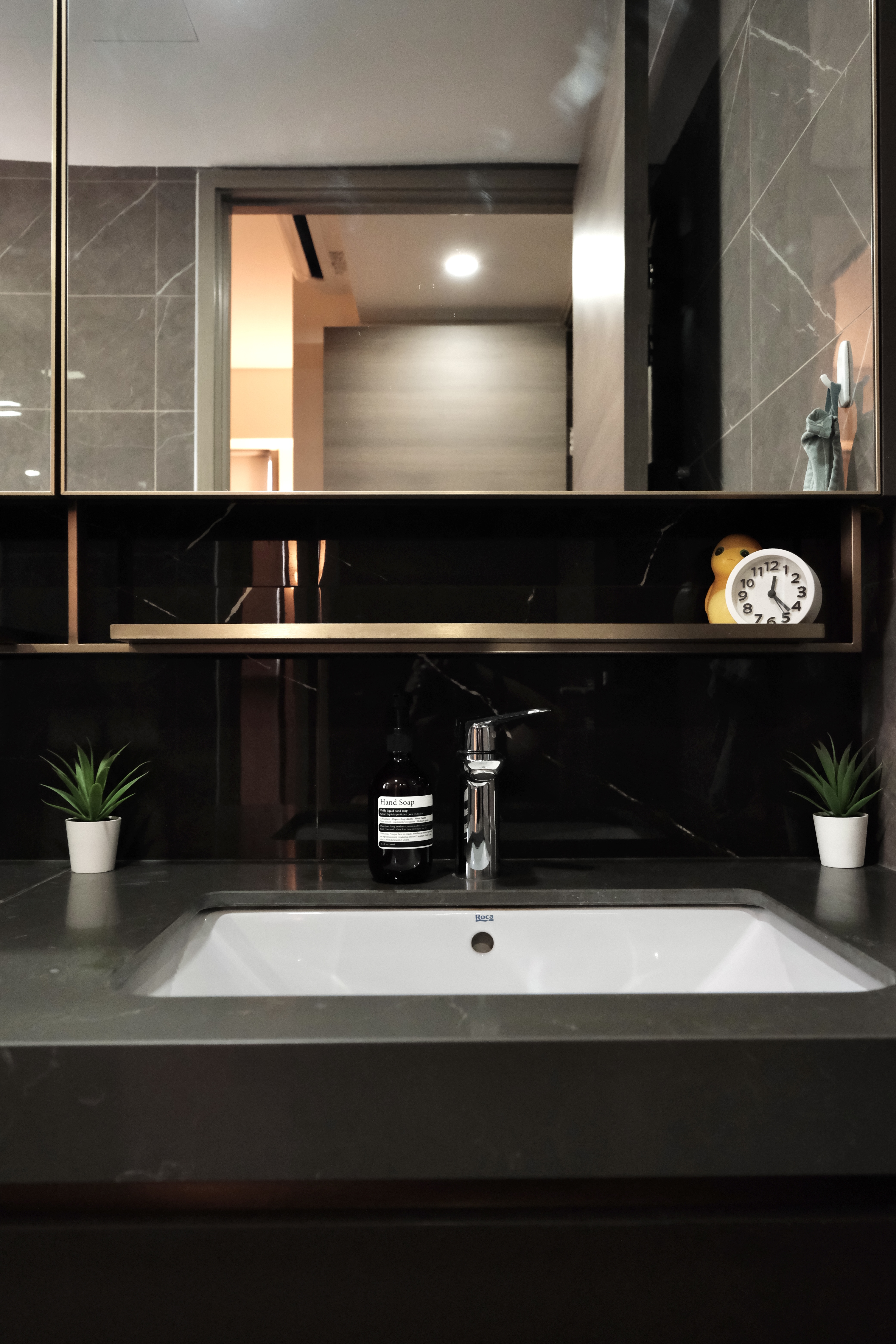Minimalist Cozy Living in the North-East - Modern bathroom vanity, sleek sink, black countertop, minimalist design, large