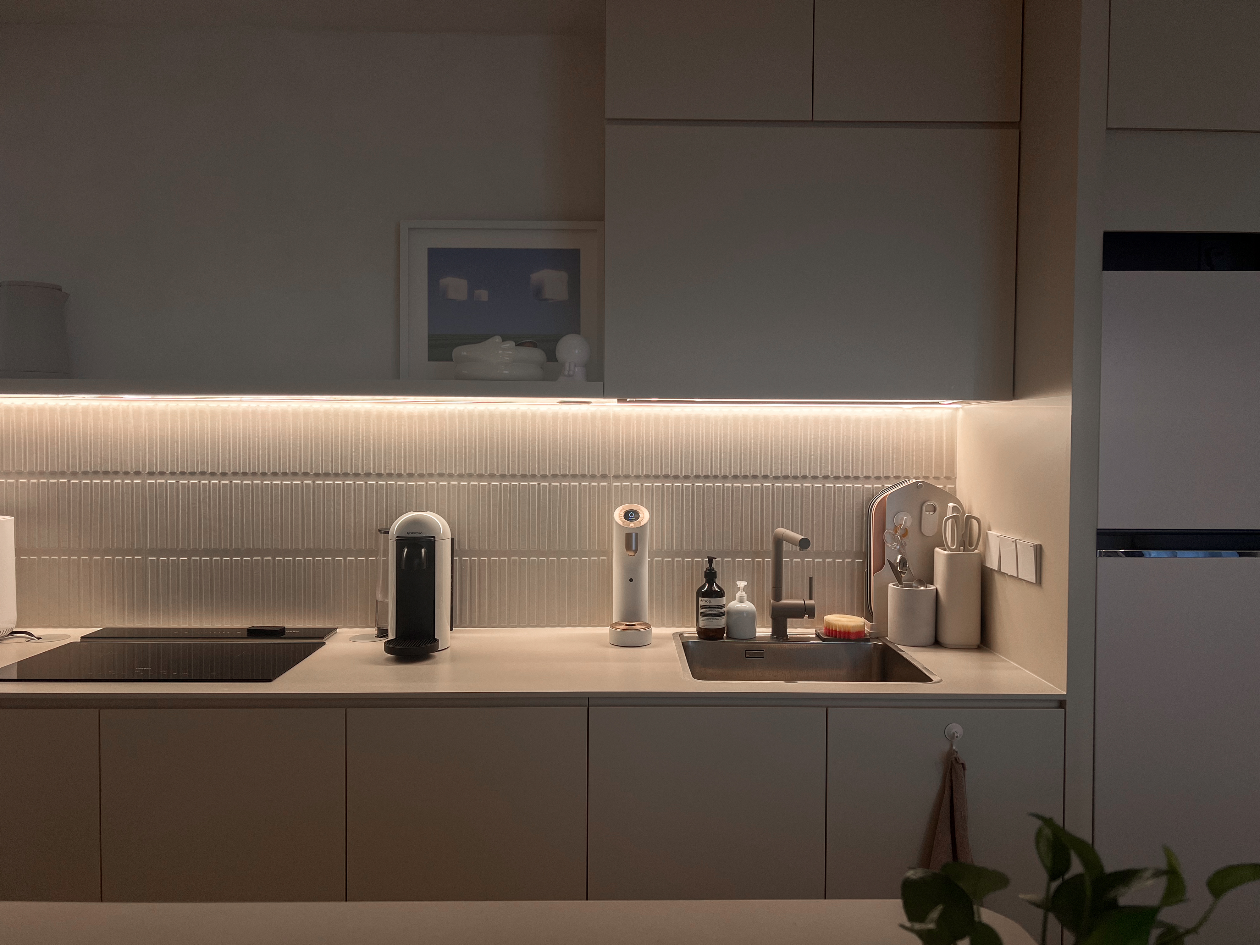 A peek inside our $130K low floor hdb loft 👀 - Modern kitchen with sleek design, minimalist decor, soft ambient lighting