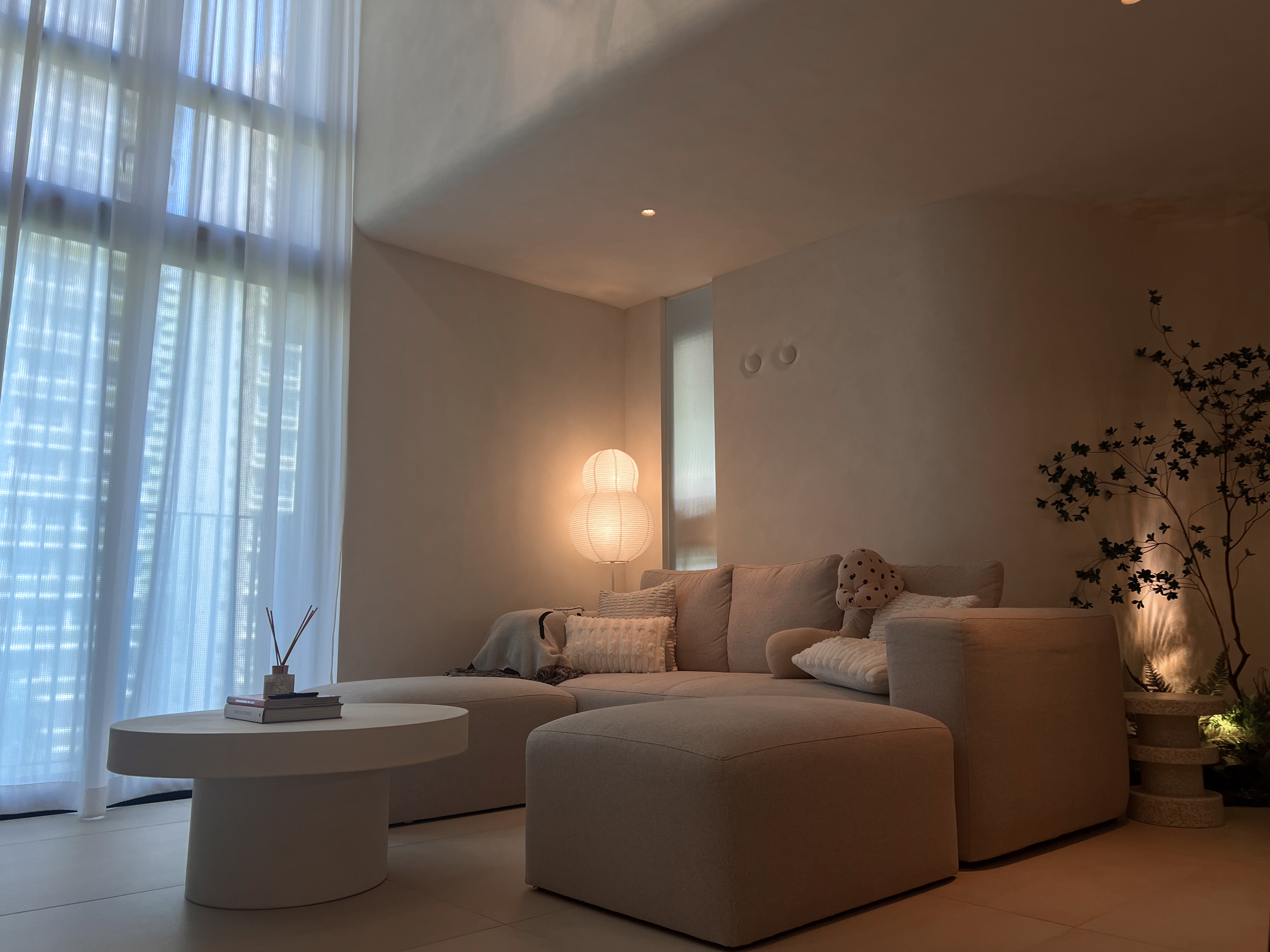 A peek inside our $130K low floor hdb loft 👀 - Soft, neutral-toned living room with modern furniture, featuring a beige