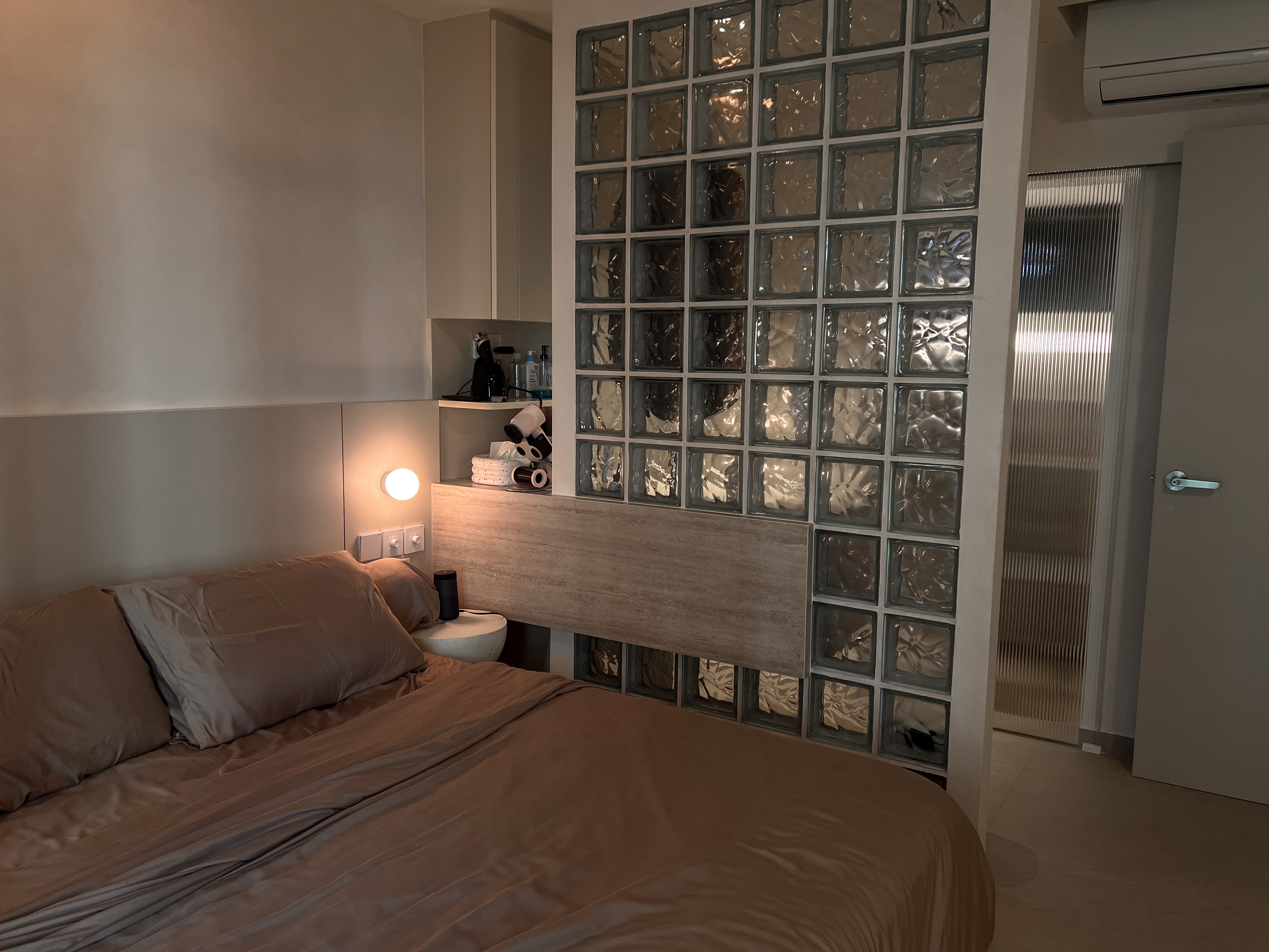 A peek inside our $130K low floor hdb loft 👀 - Modern bedroom with neatly made bed, beige bedding, soft lighting, glass