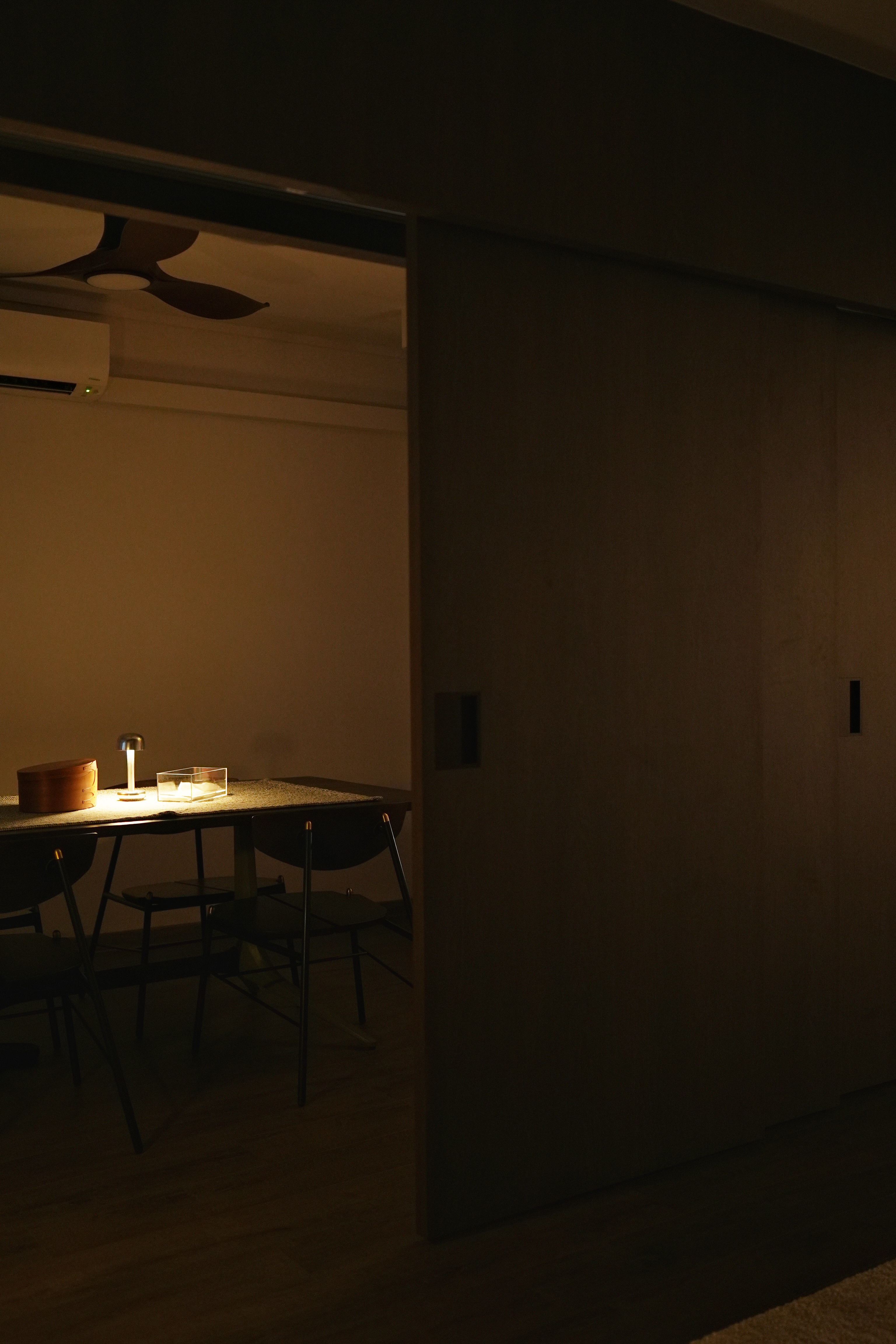 Cosy, Moody, Minimalist HDB in the Heart of the City - dimly lit room, modern furniture, wooden dining table, minimalist