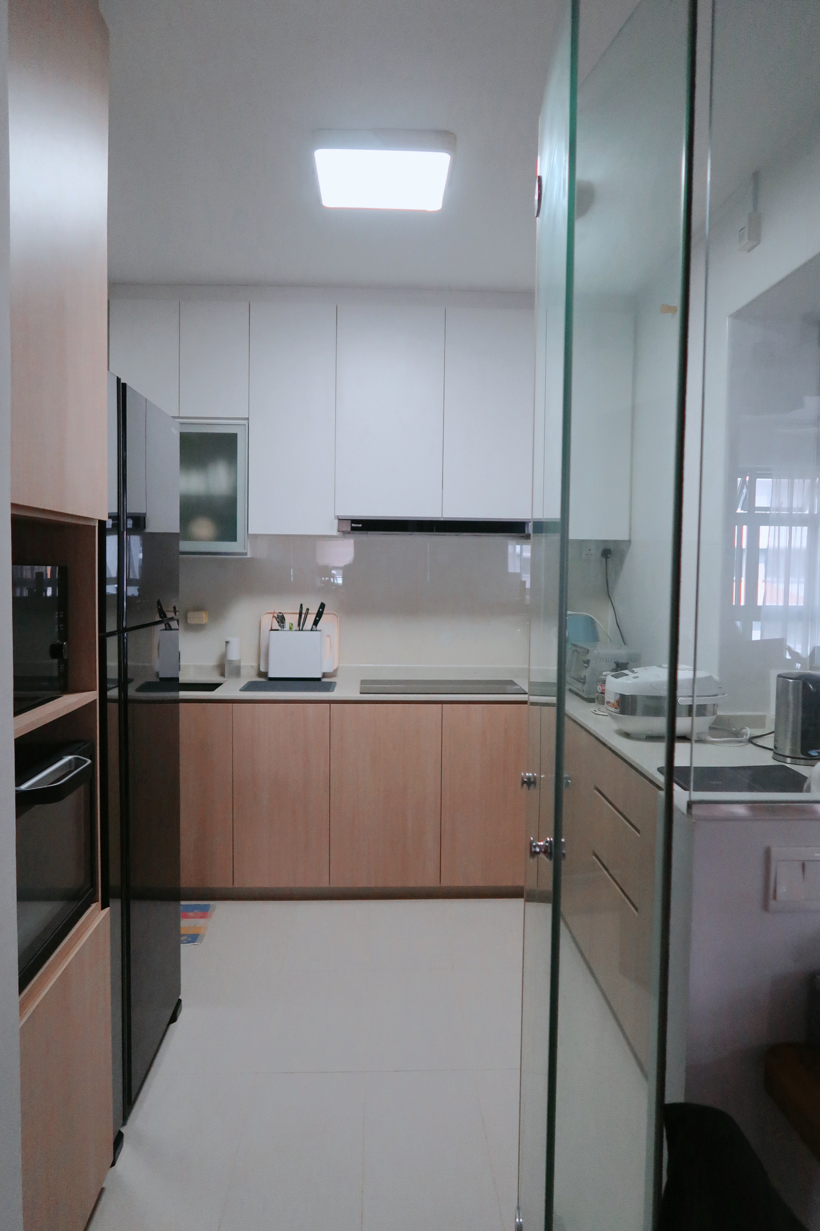 Simple Scandinavian home under $30k renovation in the East - Modern kitchen with white cabinets, stainless steel appliances