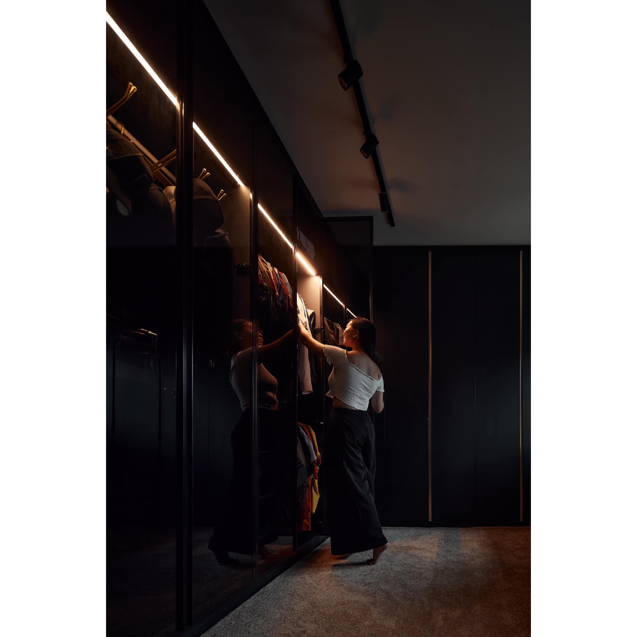 Transforming A 4-room BTO Into A $90k Modern-luxe HDB Hotel  - Dark room, modern wardrobe, illuminated interior, woman in