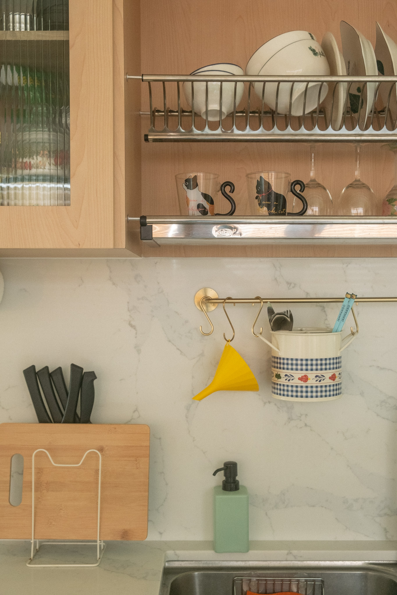 Maximising space in our cosy & quirky home with cats - Wooden kitchen cabinets, white dish rack, glassware, black and white