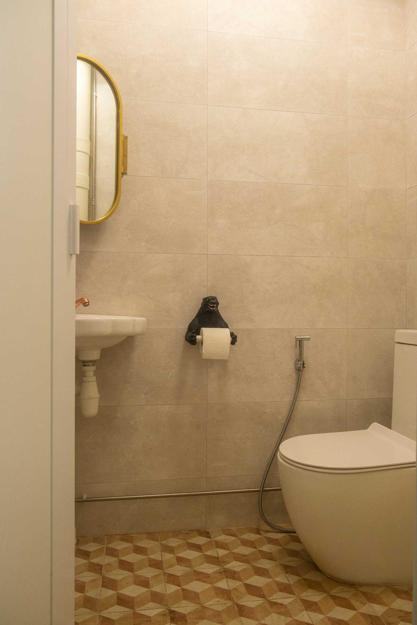 Maximising space in our cosy & quirky home with cats - Bathroom vanity with mirror, white sink, gold frame, beige tiled