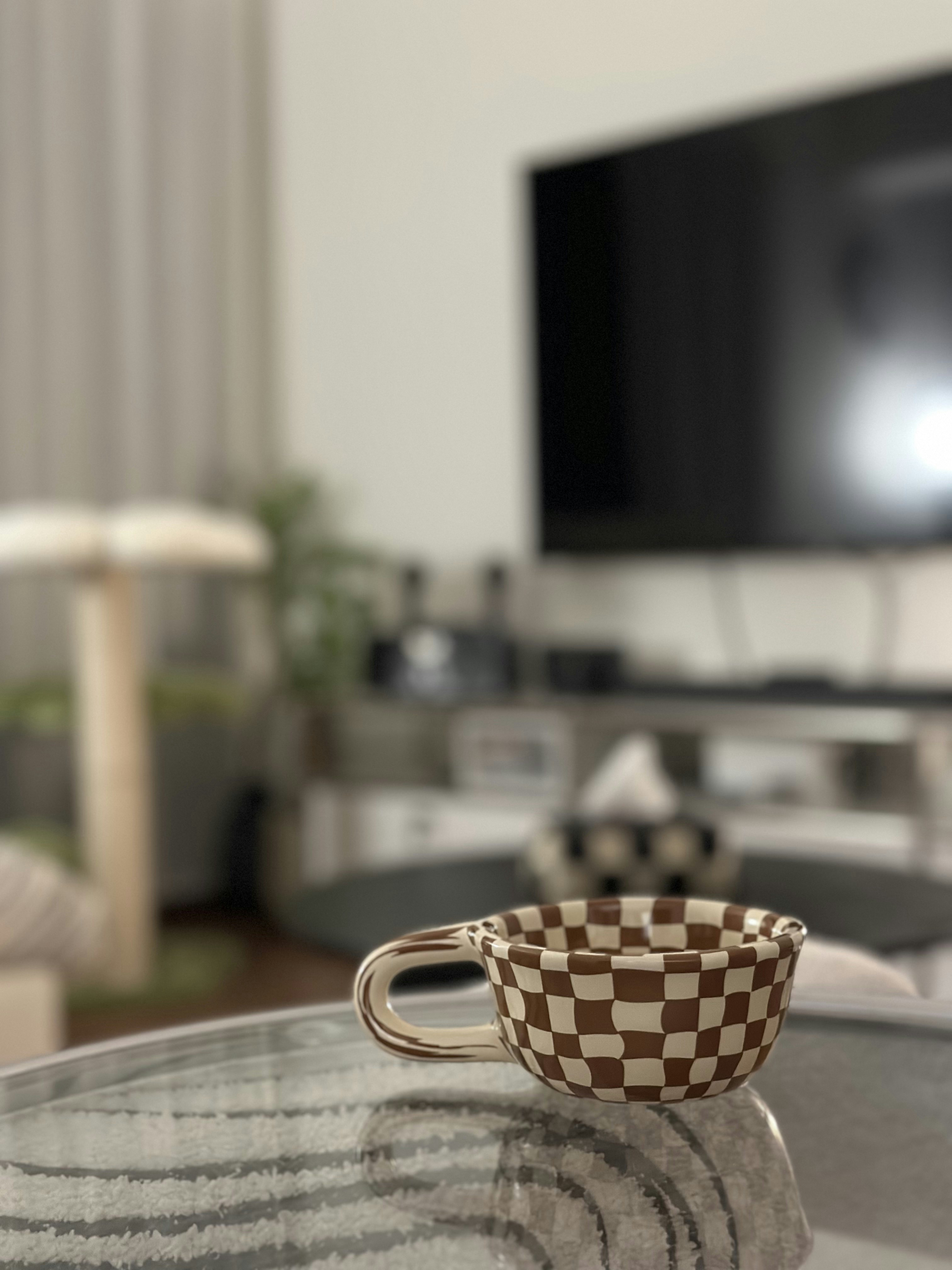 Bauhaus cathaus - $38k 4BR Reno for an open, flexible space       - Cup with checkered pattern, ceramic mug, glass table