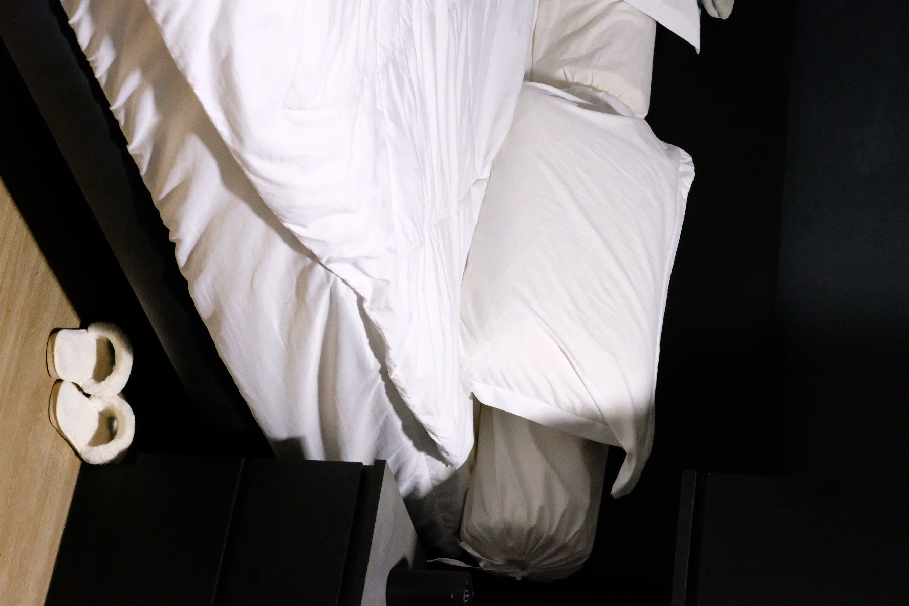 House Tour: Dark Modern Minimalist under 35k Renovation - White bedding, black nightstand, slippers, neatly made bed, soft