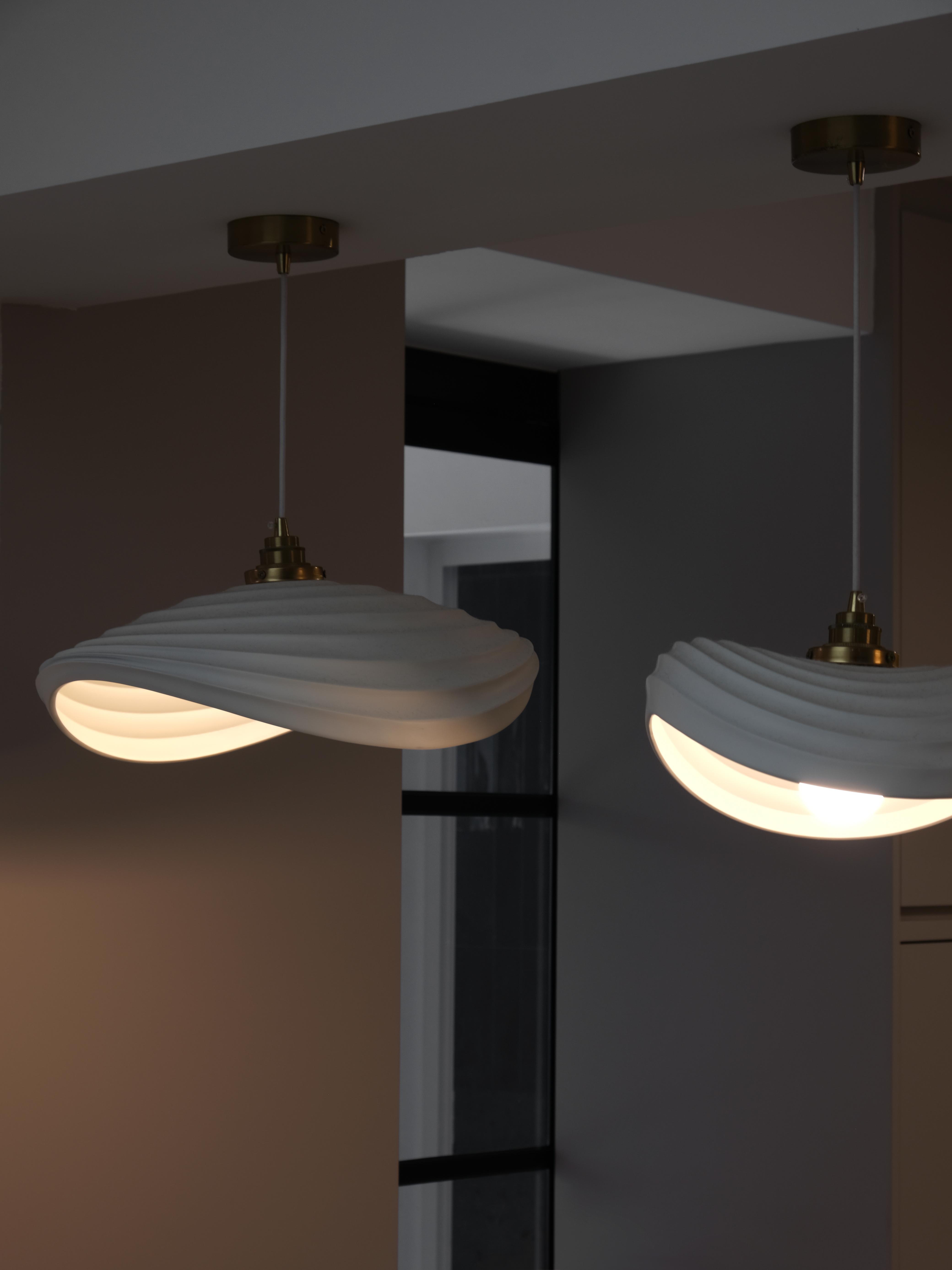 Inside a 300k Reno Modern Gallery-Inspired Maisonette - modern pendant light, white fabric shade, gold accents, minimalist