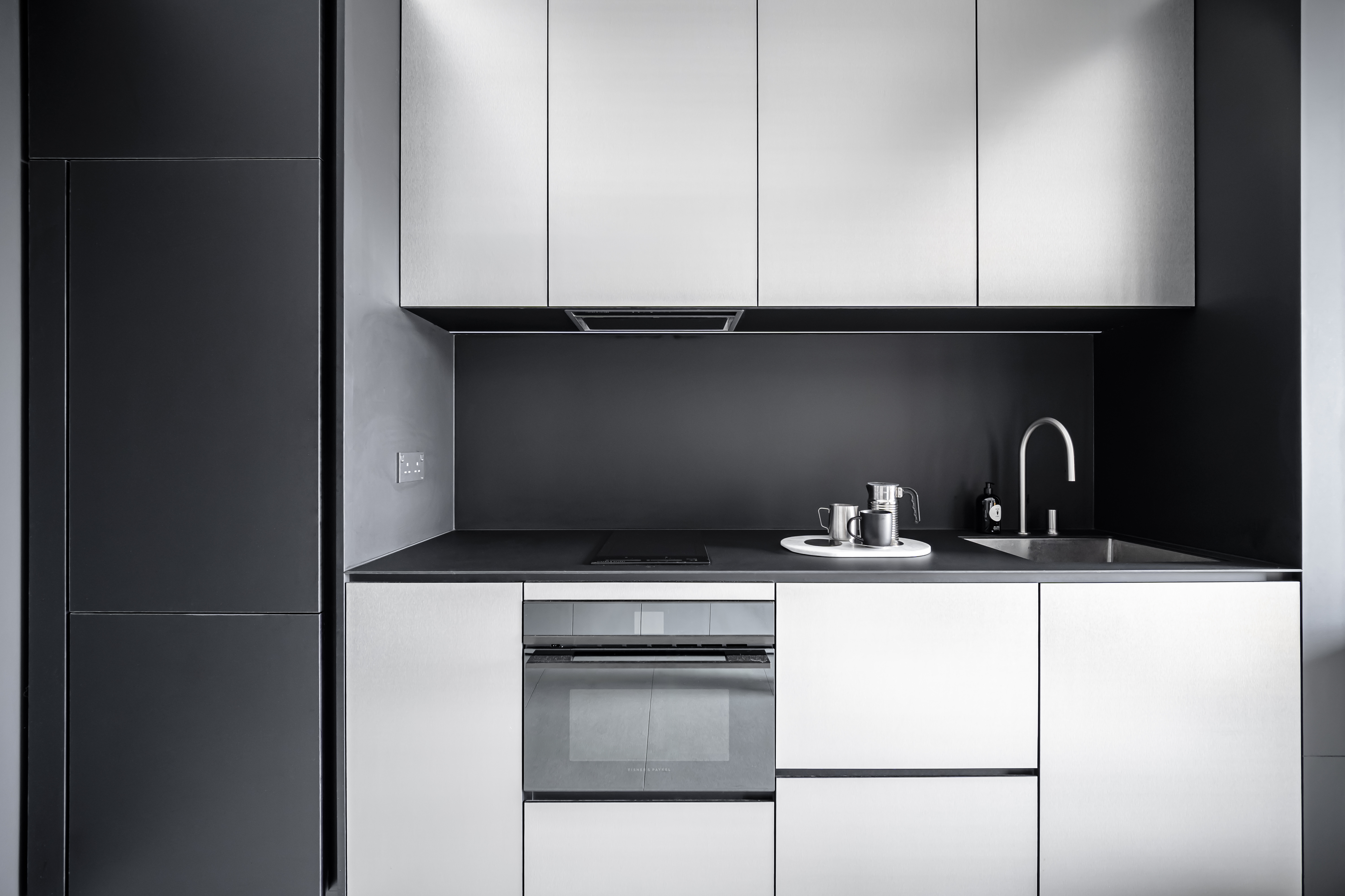 A Chic Modern Apartment Filled with Colors and Objects - Modern kitchen with sleek cabinets, minimalist design, black and