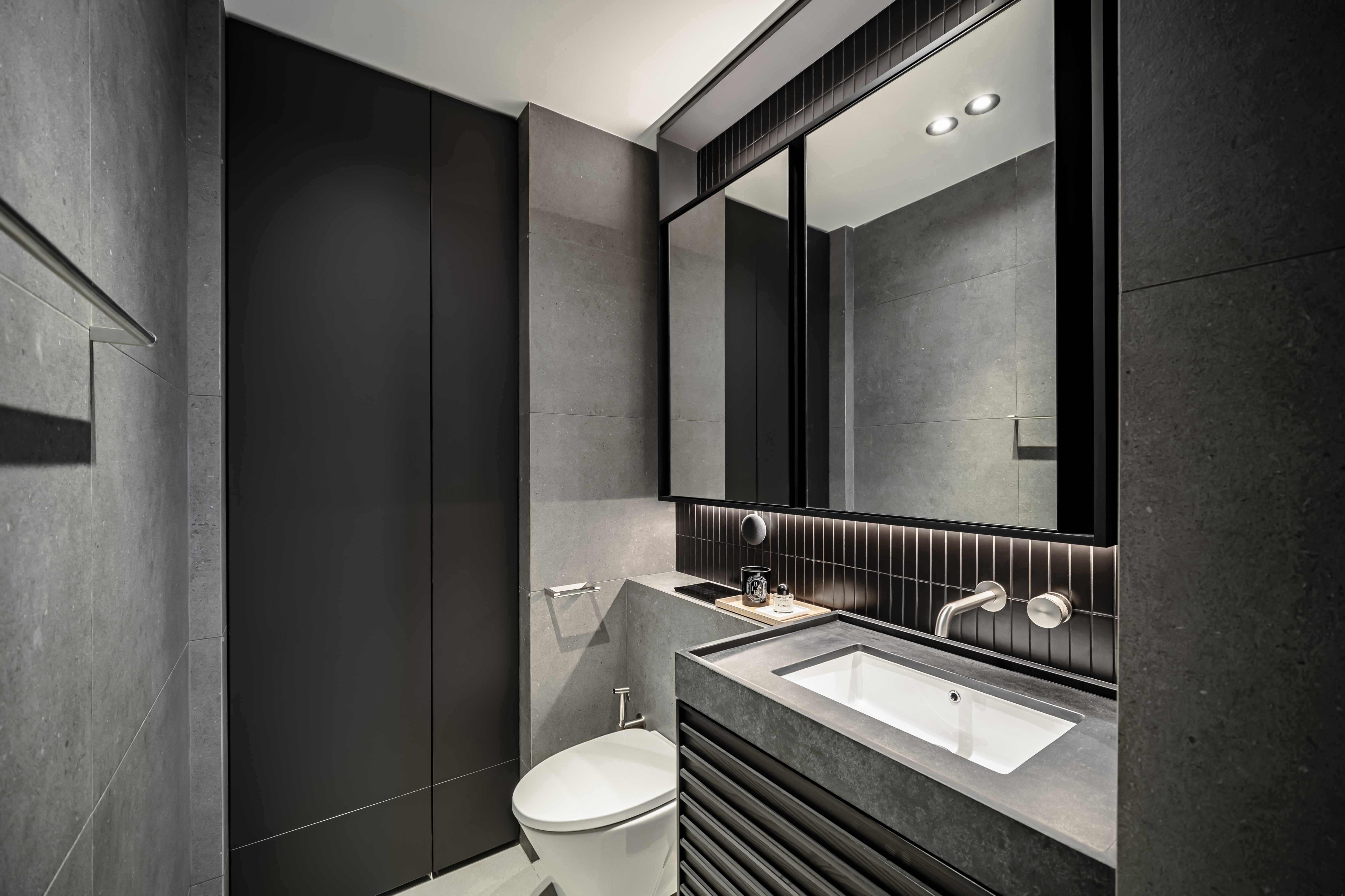 A Chic Modern Apartment Filled with Colors and Objects - Modern minimalist bathroom, sleek design, dark gray walls