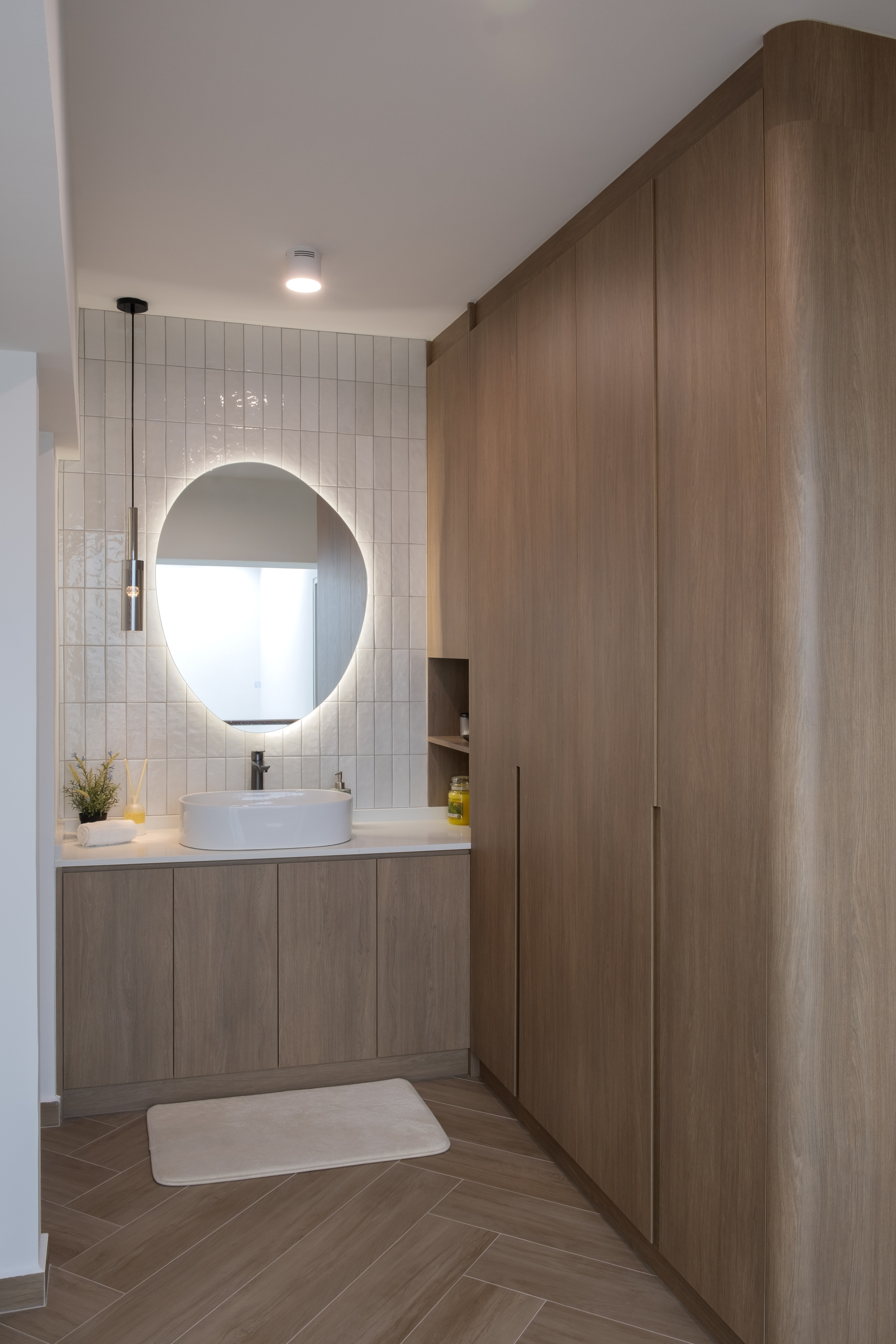 Inside a 300k Reno Modern Gallery-Inspired Maisonette - Modern bathroom with sleek design, white tiled walls, oval-shaped