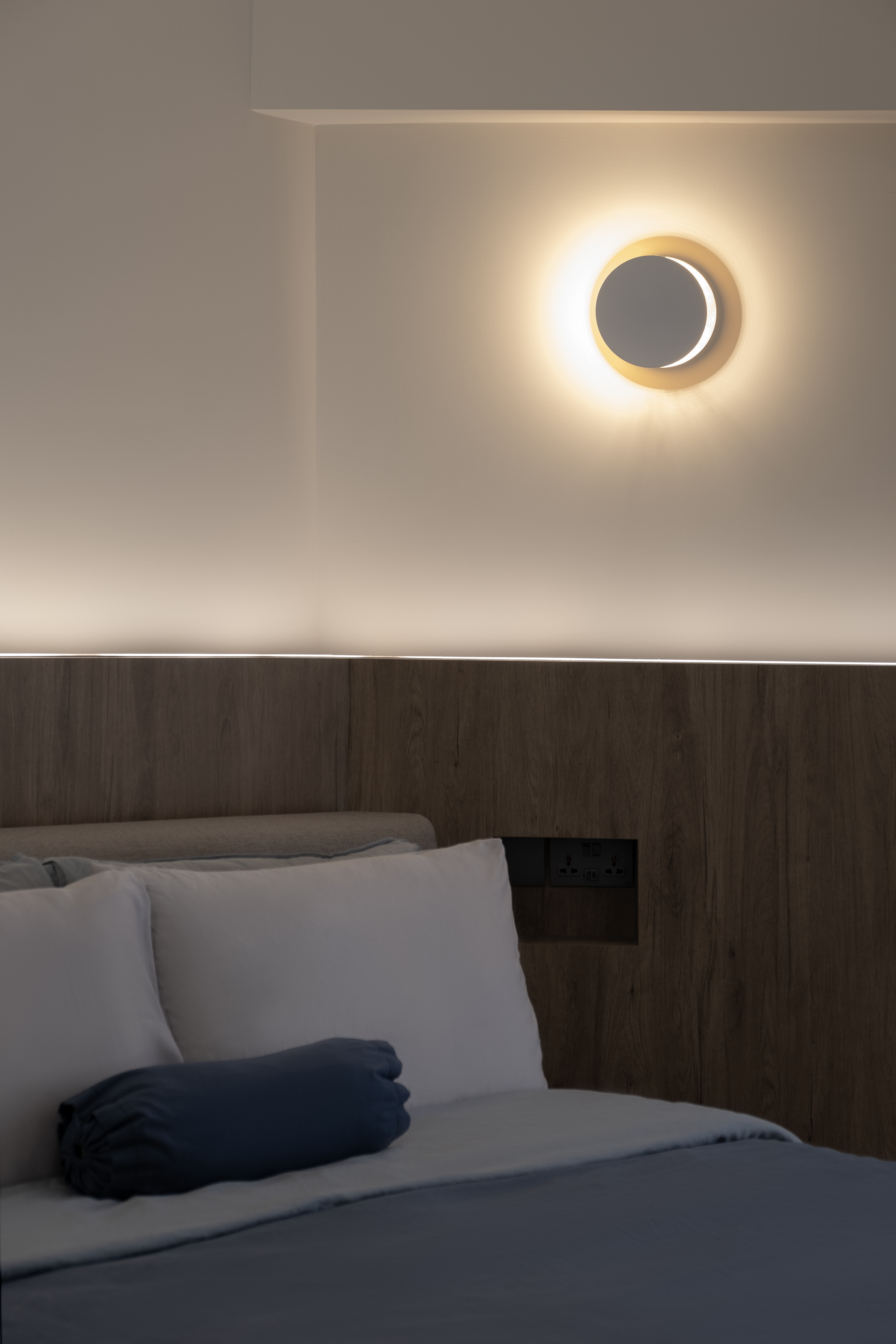 Inside a 300k Reno Modern Gallery-Inspired Maisonette - Modern minimalist bedroom, soft ambient lighting, circular wall