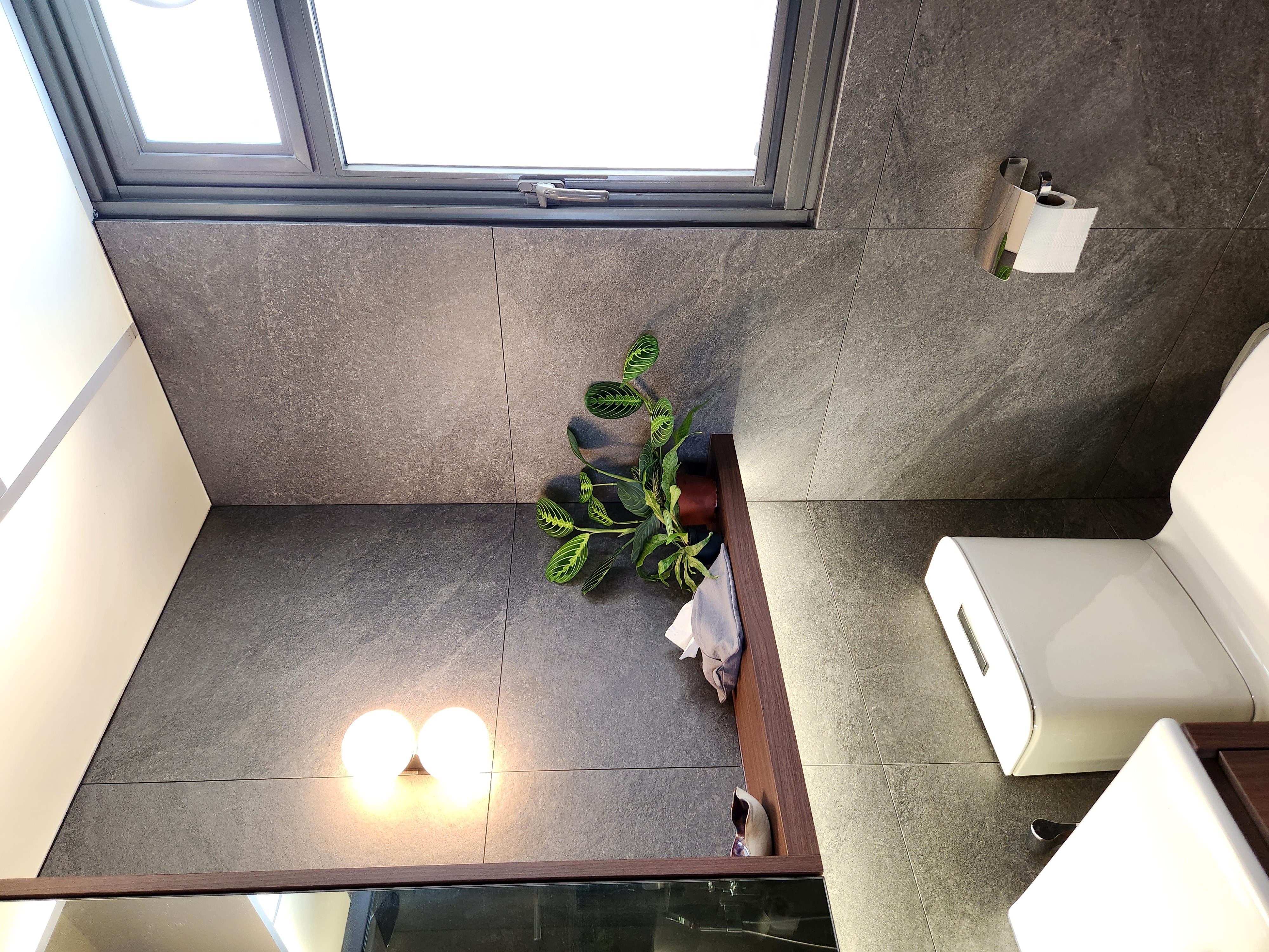 Step into our wood and pottery-filled 5-Room BTO - modern bathroom interior, gray stone tiles, sleek design, minimalist