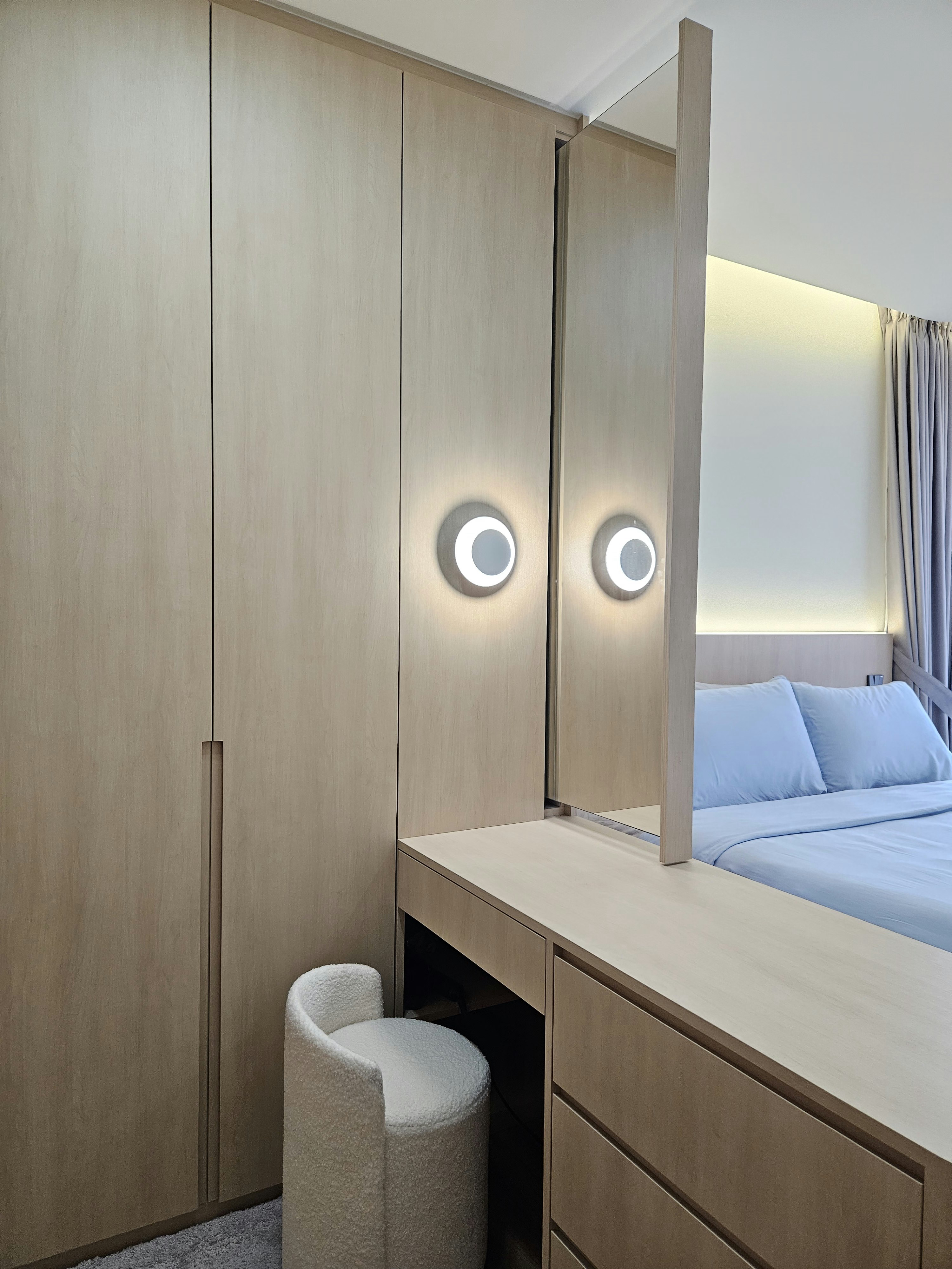 Step into our wood and pottery-filled 5-Room BTO - Wooden wardrobe with sleek design, illuminated circular lights, minimalist