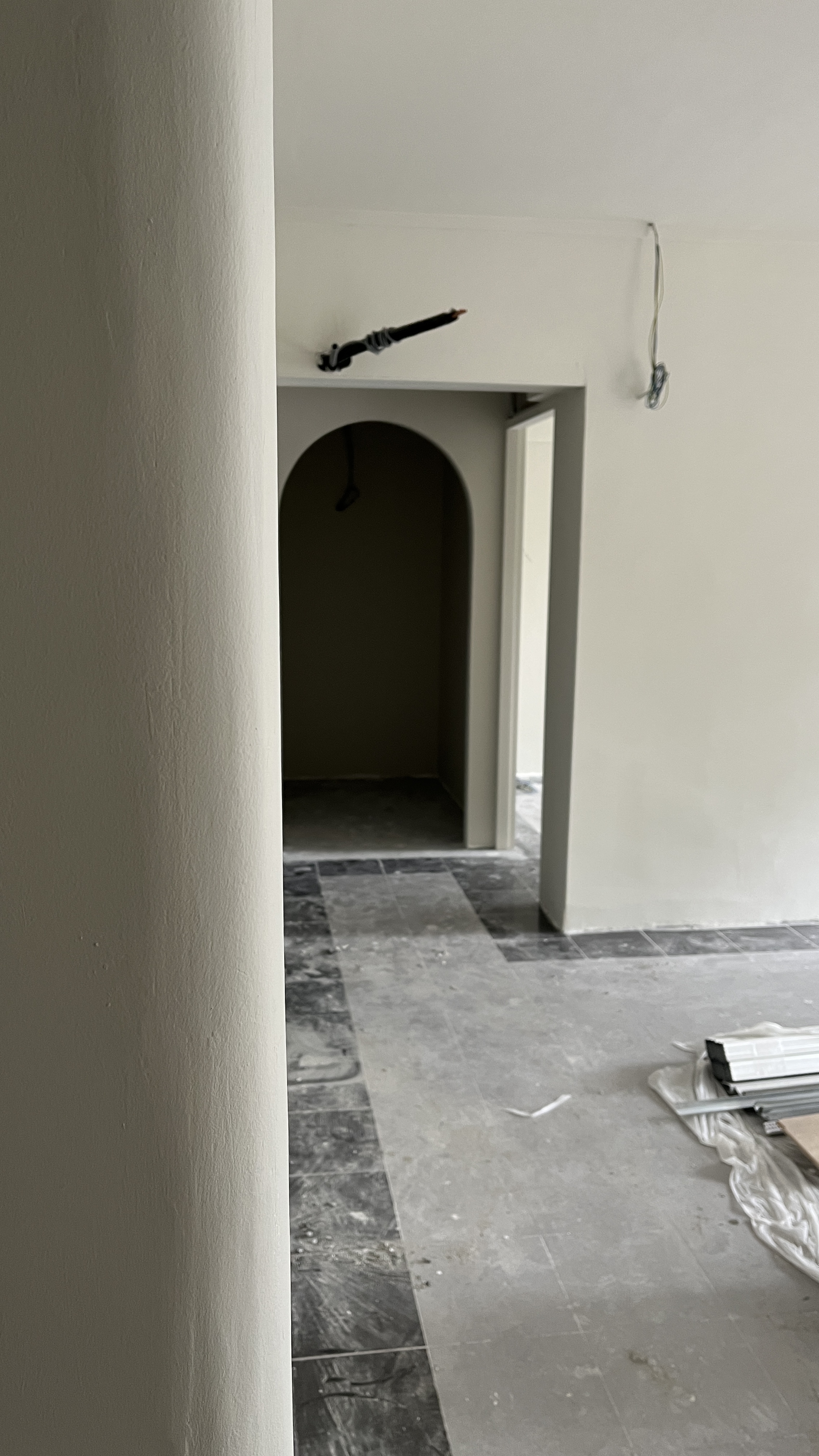 Tips & Tricks for Renovation Rendering - White column, unfinished walls, dark archway, construction site, tiled floor