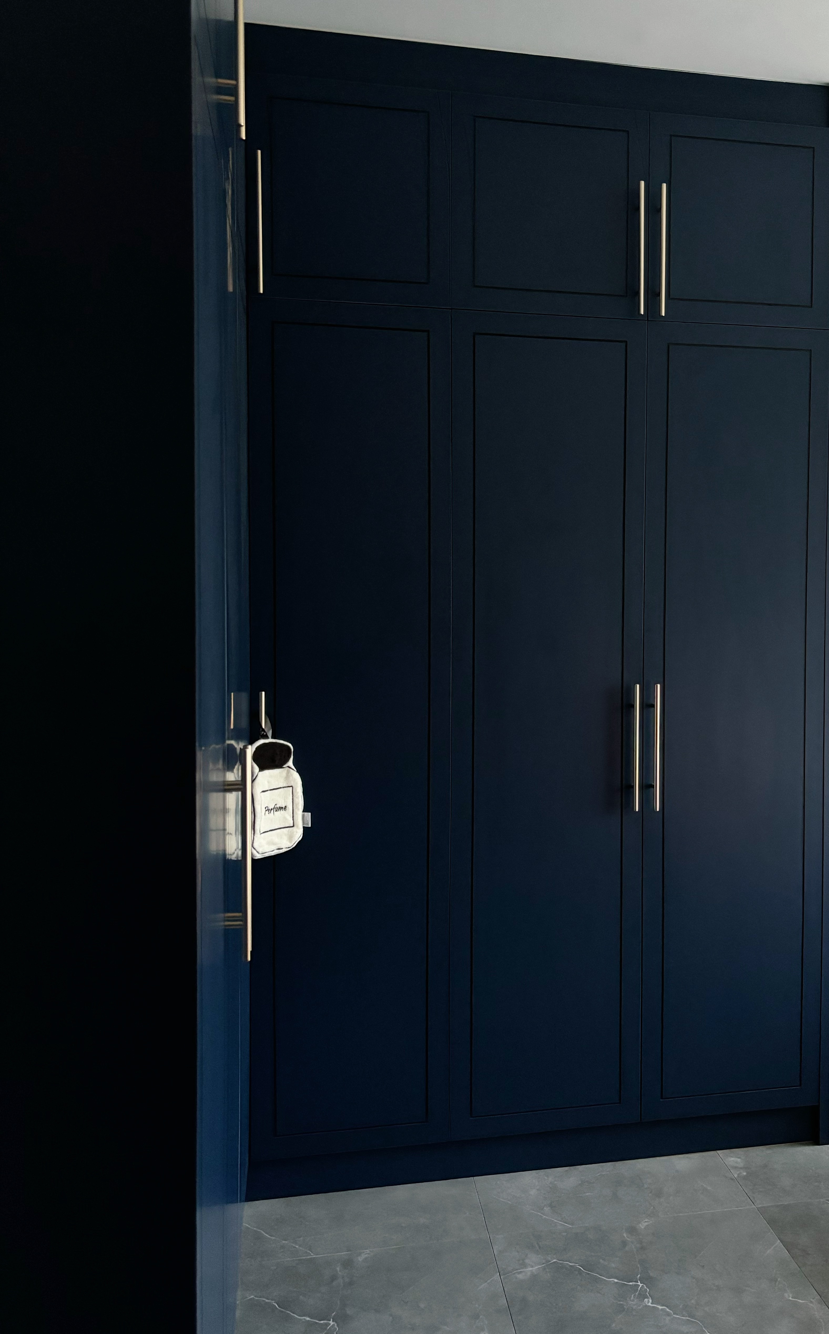 The Magic of Home by Potterhomeadventures - Dark navy blue cabinet with gold handles, sleek design, modern aesthetic