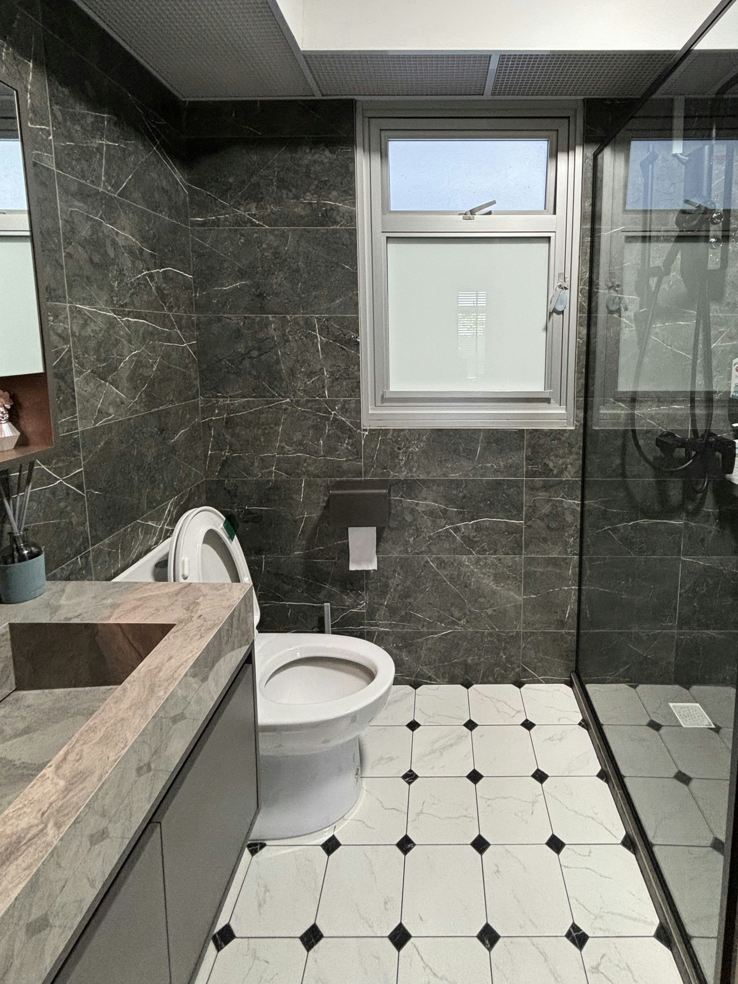 The Magic of Home by Potterhomeadventures - Dark marble walls, white toilet, glass shower enclosure, black and white tiled