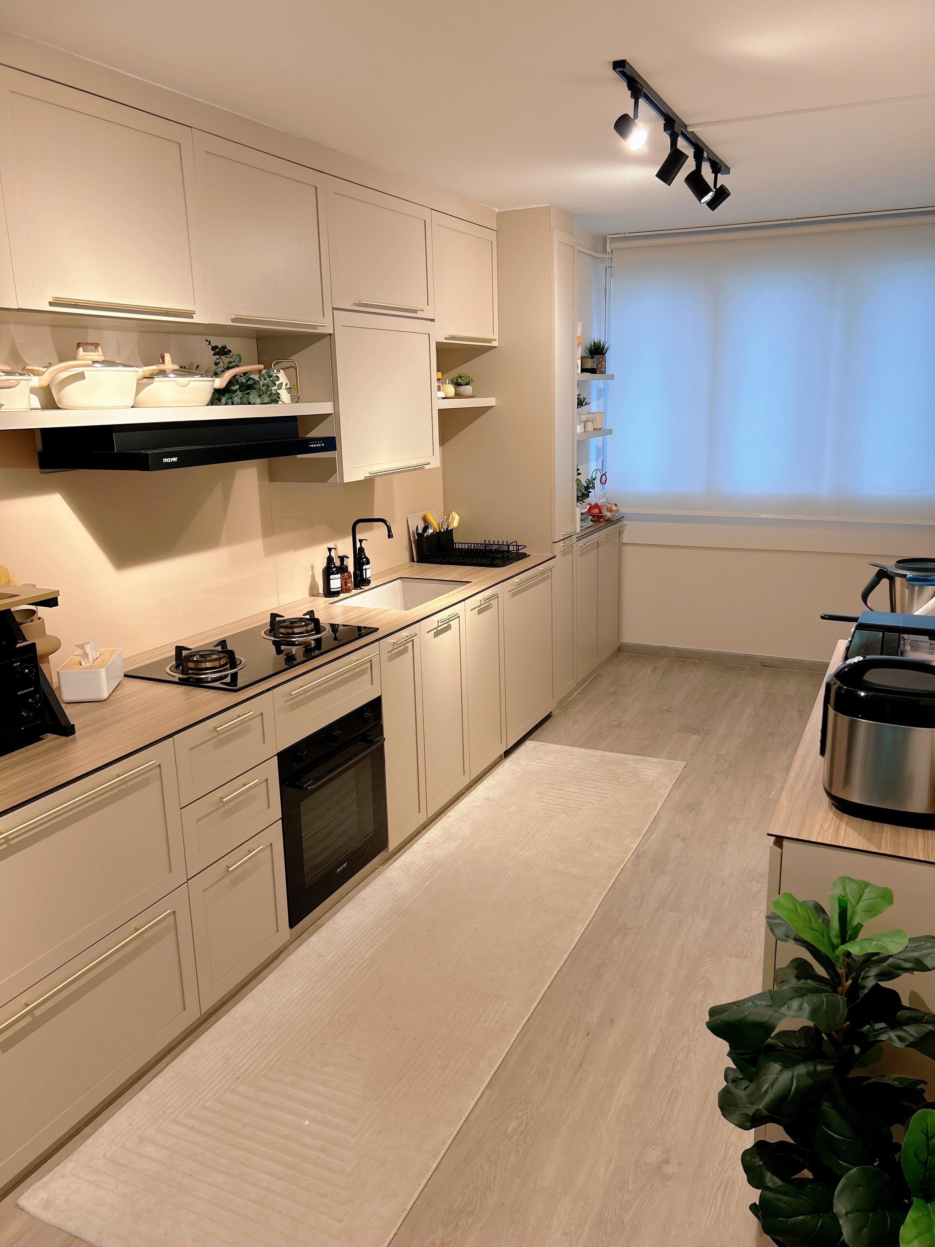 An Open-Concept Galley Kitchen: Where Style Meets Function - Modern kitchen with beige cabinets, black range hood, stainless