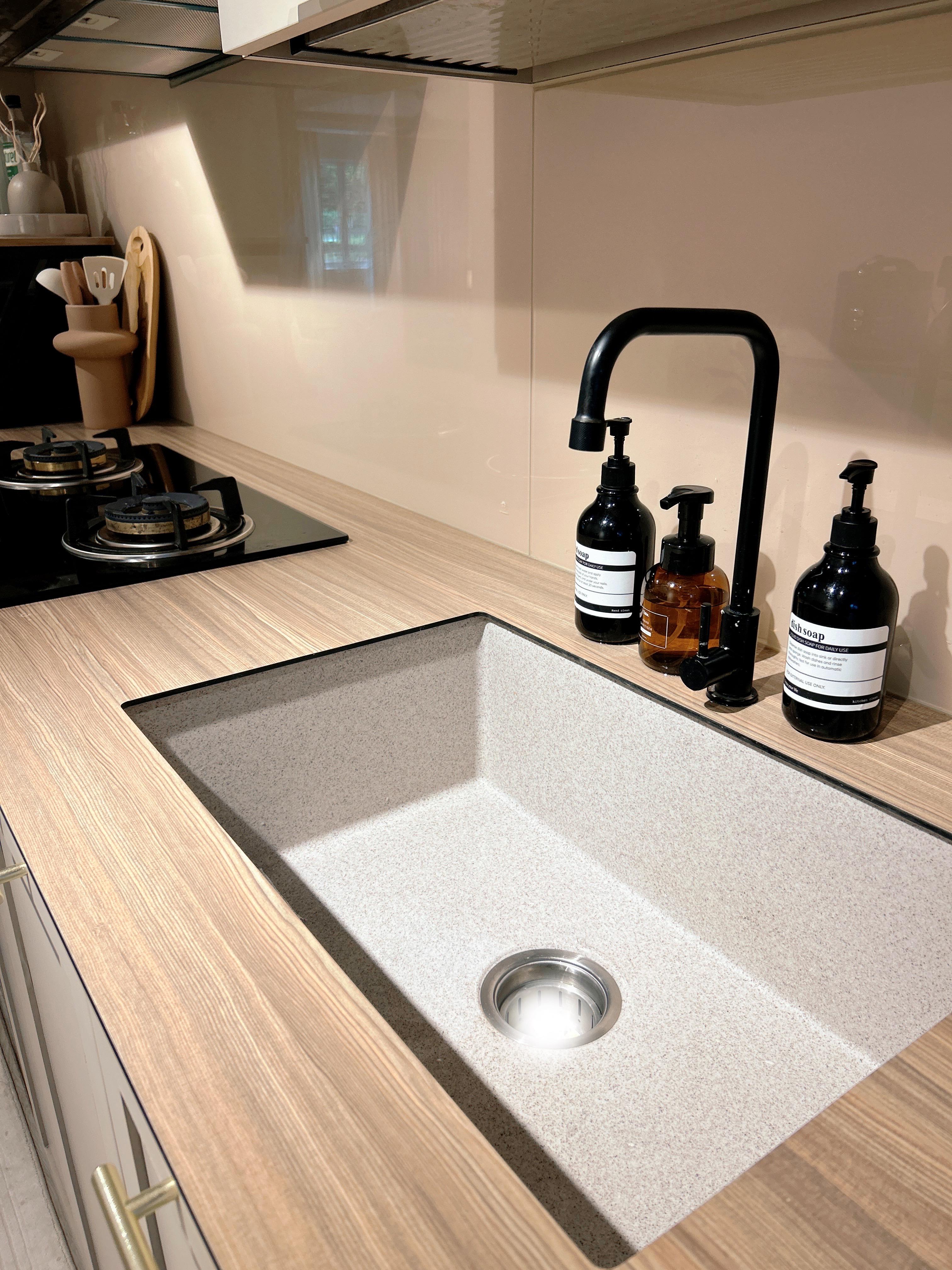 An Open-Concept Galley Kitchen: Where Style Meets Function - Wooden kitchen countertop, modern sink, stainless steel drain