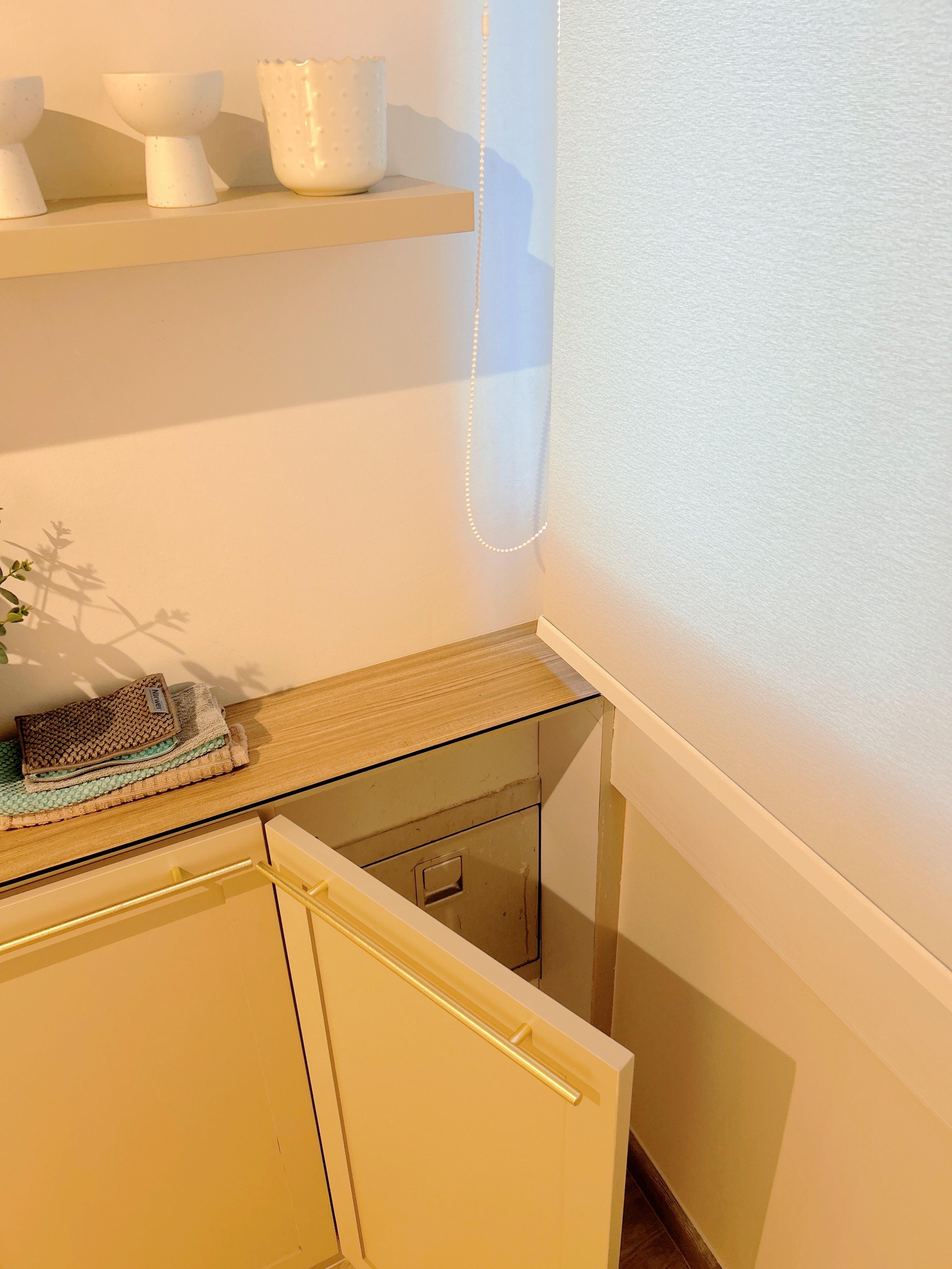 An Open-Concept Galley Kitchen: Where Style Meets Function - White ceramic bowls, beige countertop, wooden cabinet, gold