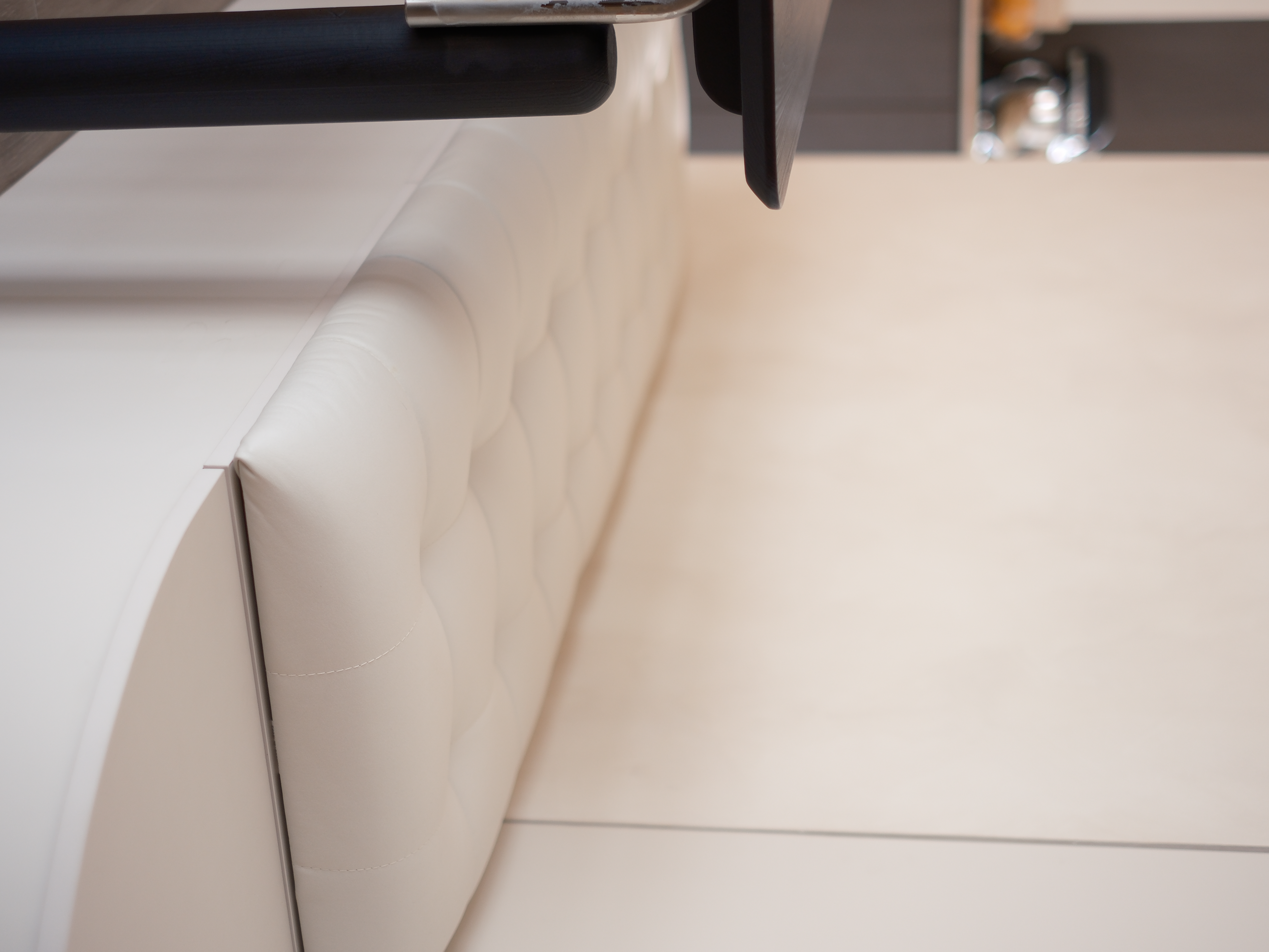 Embracing Minimalism in our Airy Dining Nook  - modern sofa, cushioned armrest, sleek design, minimalist decor, contemporary