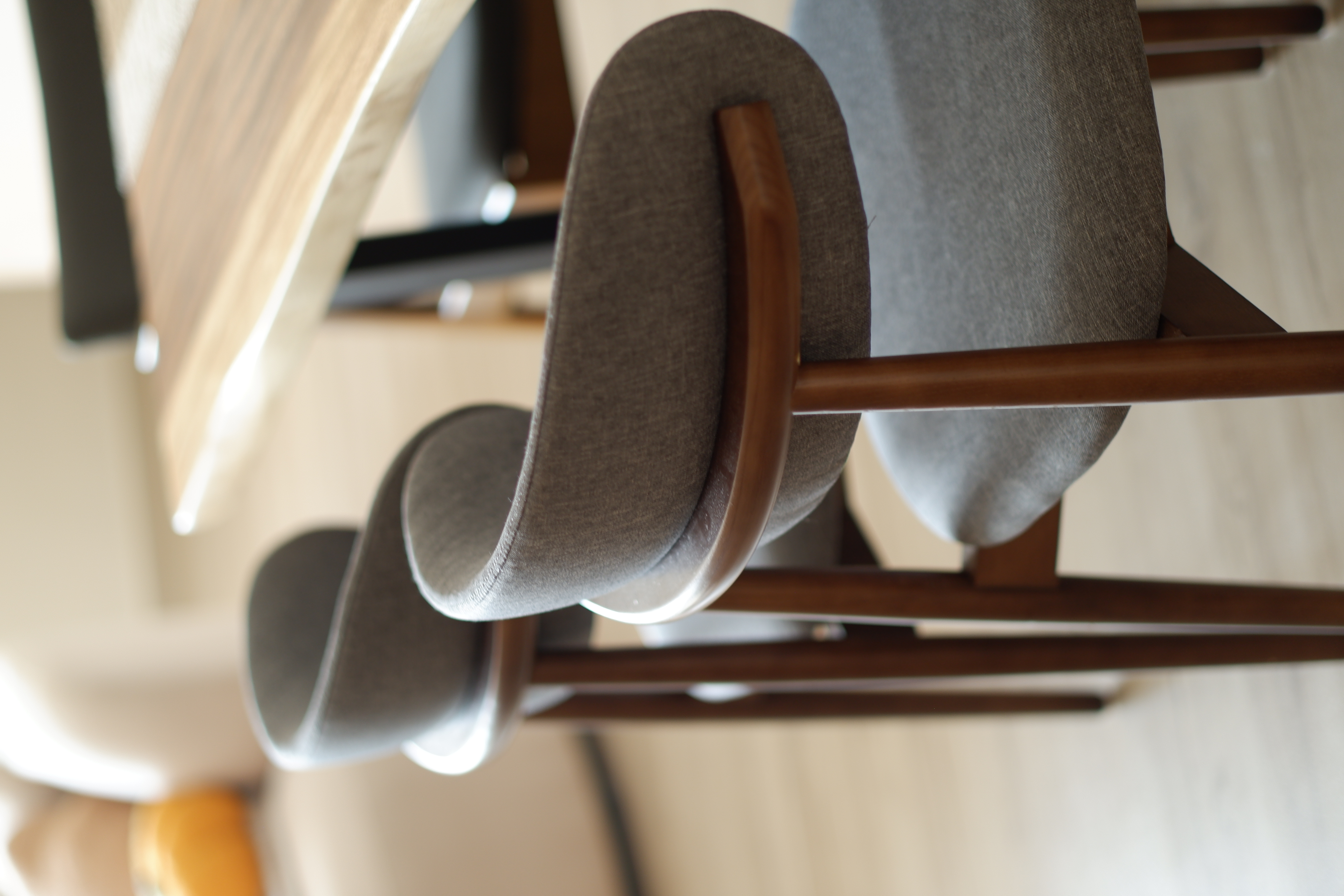 Dining Area - a cosy place where we host family and friends - Modern chair with wooden armrests and gray fabric upholstery