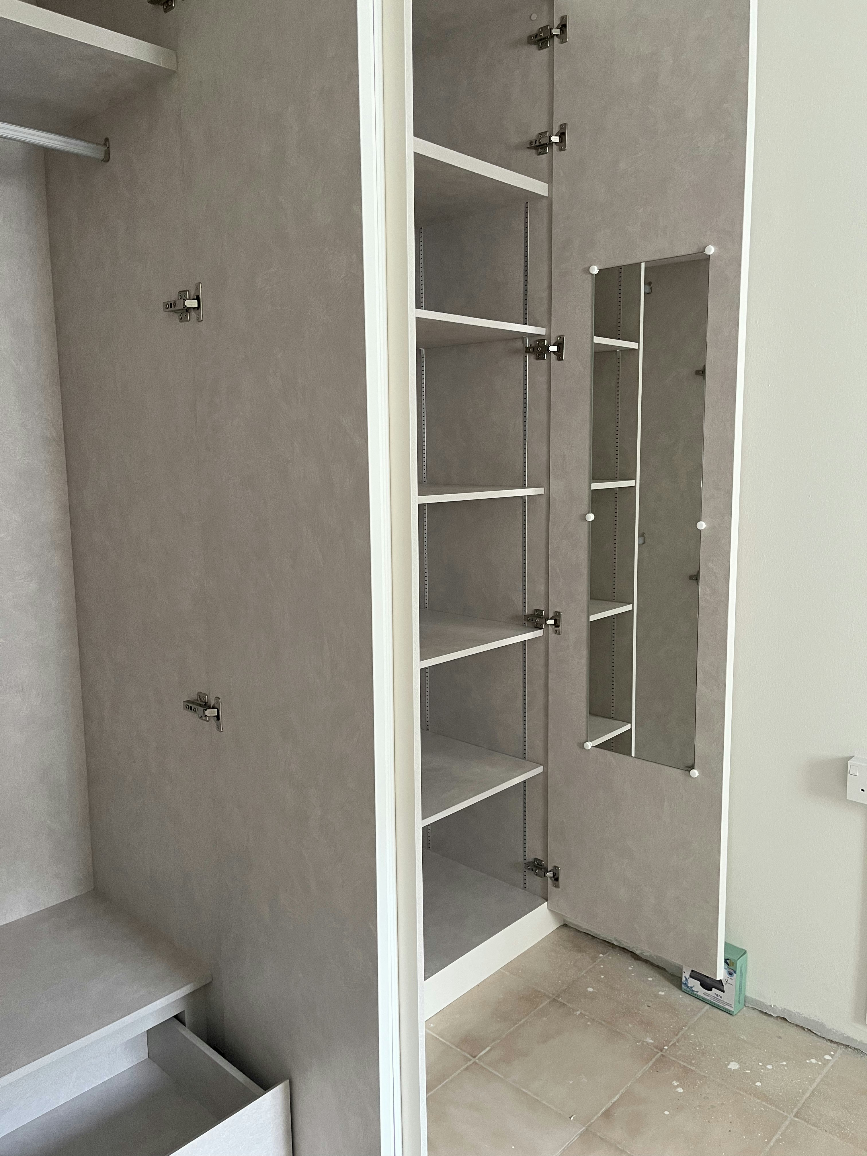 Light, white and bright ✨ - Gray textured wall, white shelving unit, open closet door, metal hinges, minimalist design