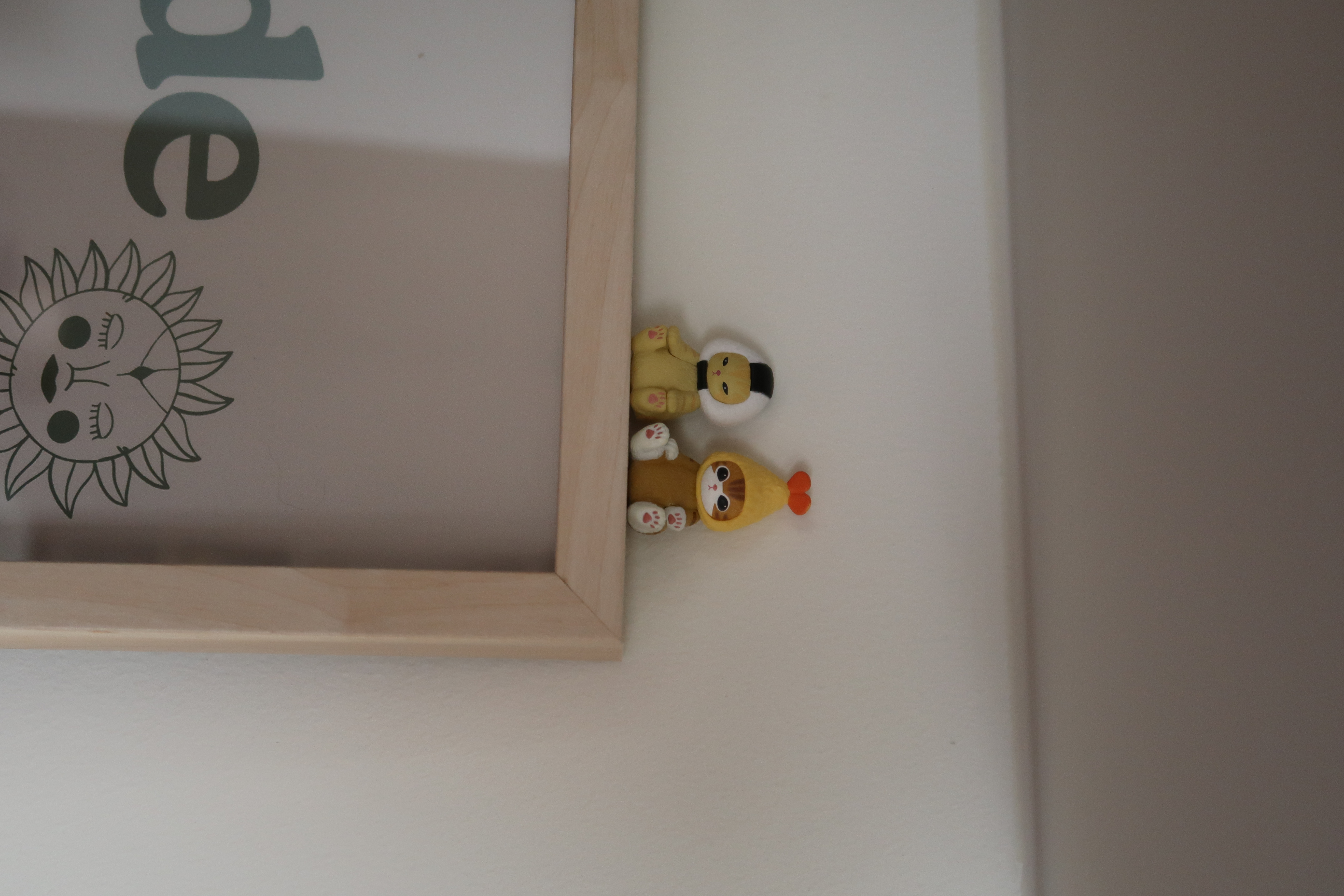 How we elevated our living space in 3 simple ways! - Sunflower-themed figurines, wooden frame, cute animal design, yellow and