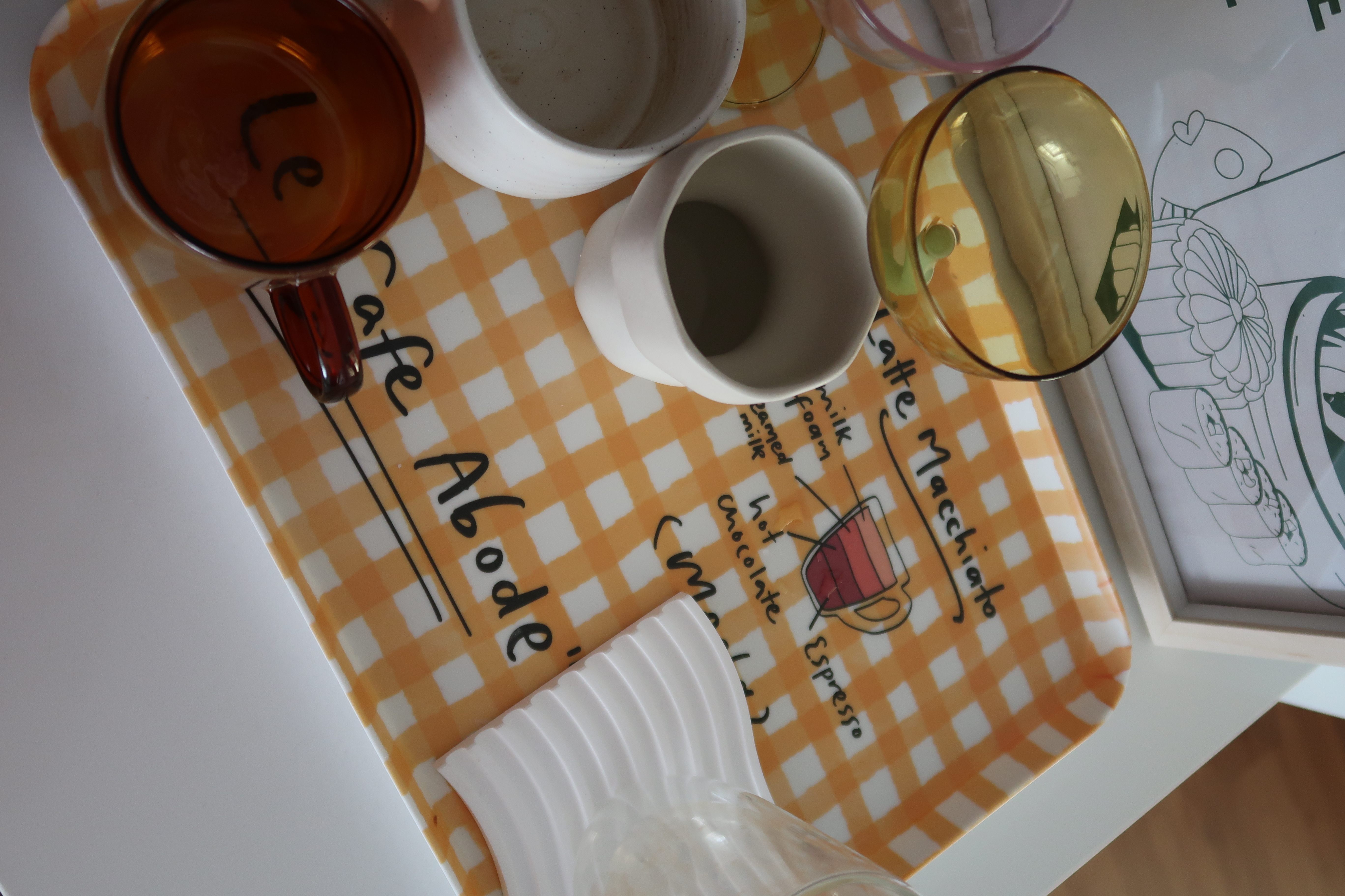 How we elevated our living space in 3 simple ways! - Café, table, glasses, tea, coffee, orange checkered placemat, white