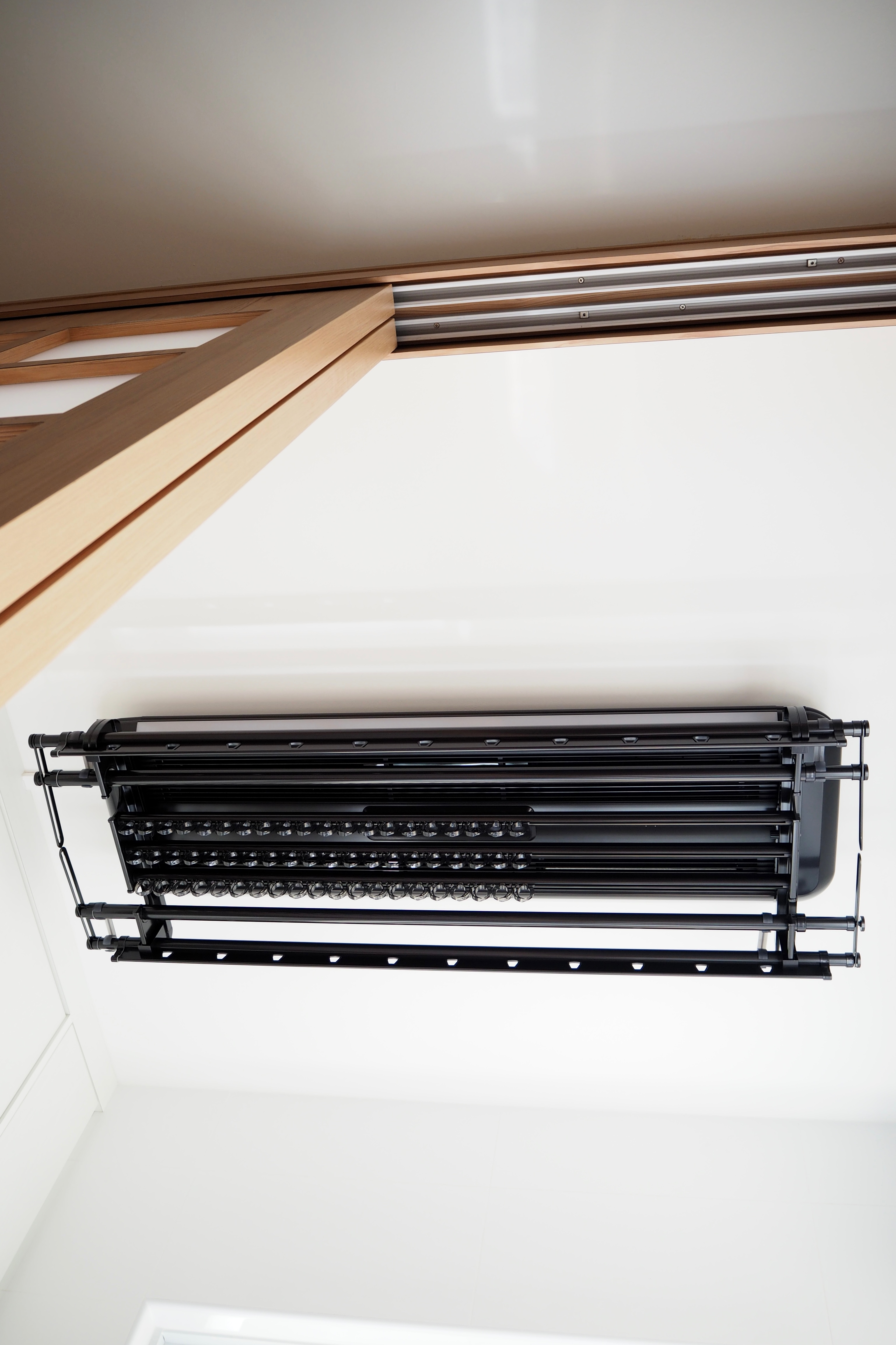 Creating a service yard for under $2.3k - Modern ceiling air conditioning unit, sleek black design, integrated control panel