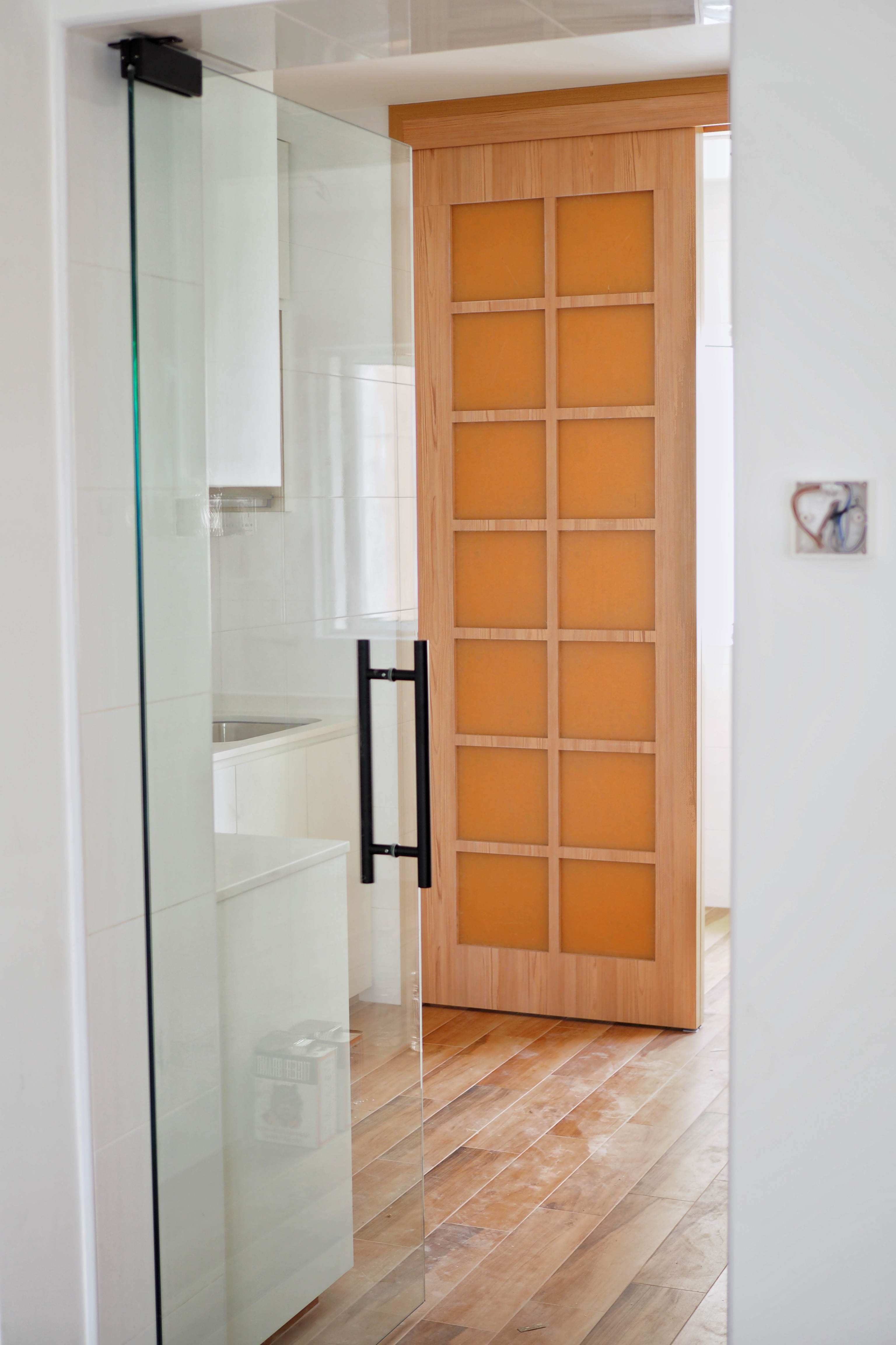 Creating a service yard for under $2.3k - Glass shower enclosure, wooden door, modern bathroom, white tiles, wooden panel