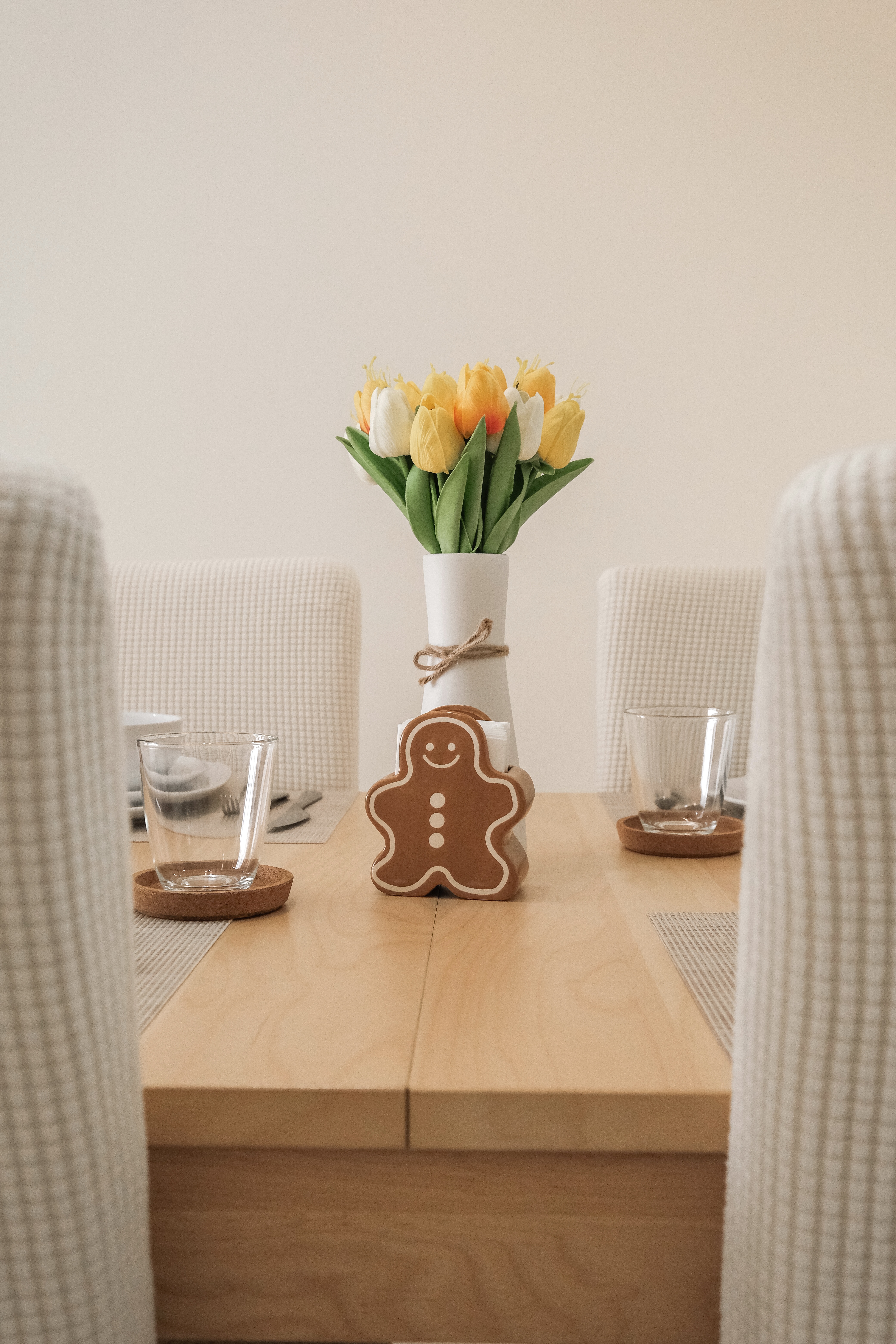 4 guests? 10 guests? Not a problem for our minimalist dining space! - vase with yellow and white tulips, wooden table, clear